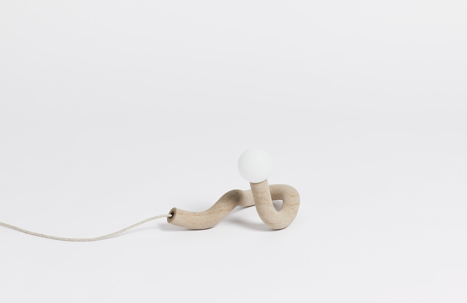Hot Wire Extensions' Native Light 5. A small desk light with natural textile cable and a raw, sealed finish