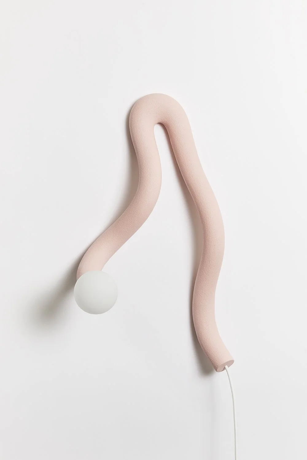 Hot Wire Extensions Native Light 12. A wall mounted light with natural textile cable and a raw, sealed finish