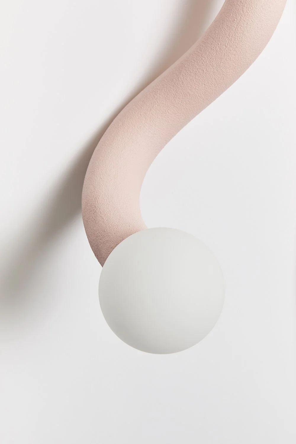 Hot Wire Extensions Native Light 12. A wall mounted light with natural textile cable and a raw, sealed finish