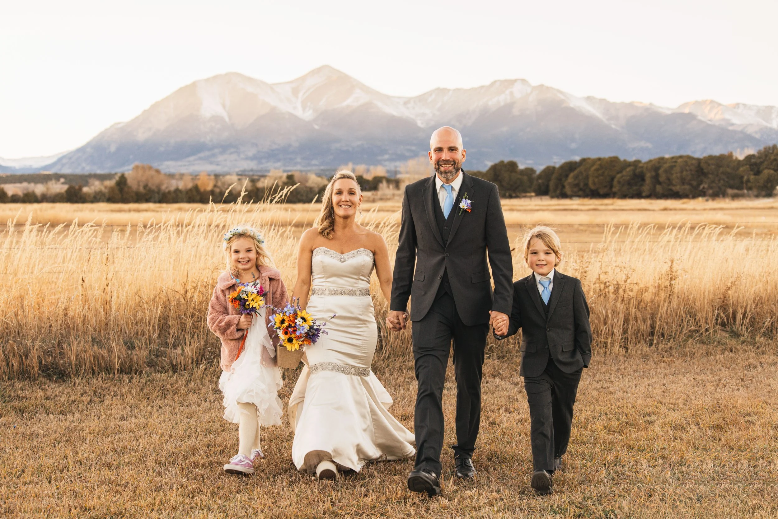  Experience the pure bliss of a wedding day where love knows no bounds. This enchanting image showcases a radiant bride and groom, surrounded by the warmth of their loving family. The air is filled with love and joy as they exchange vows, creating un