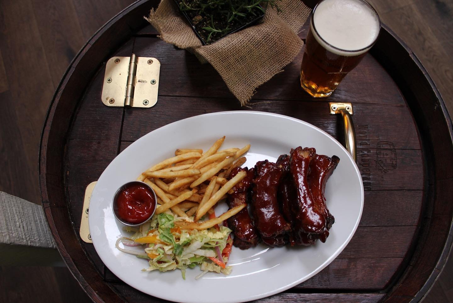☀️ Summer officially begins! Swing by and try our juicy Backyard Baby Back Pork Ribs that fall off the bone 🤤🍖 combined with our house-made BBQ sauce, coleslaw and shoestring fries!