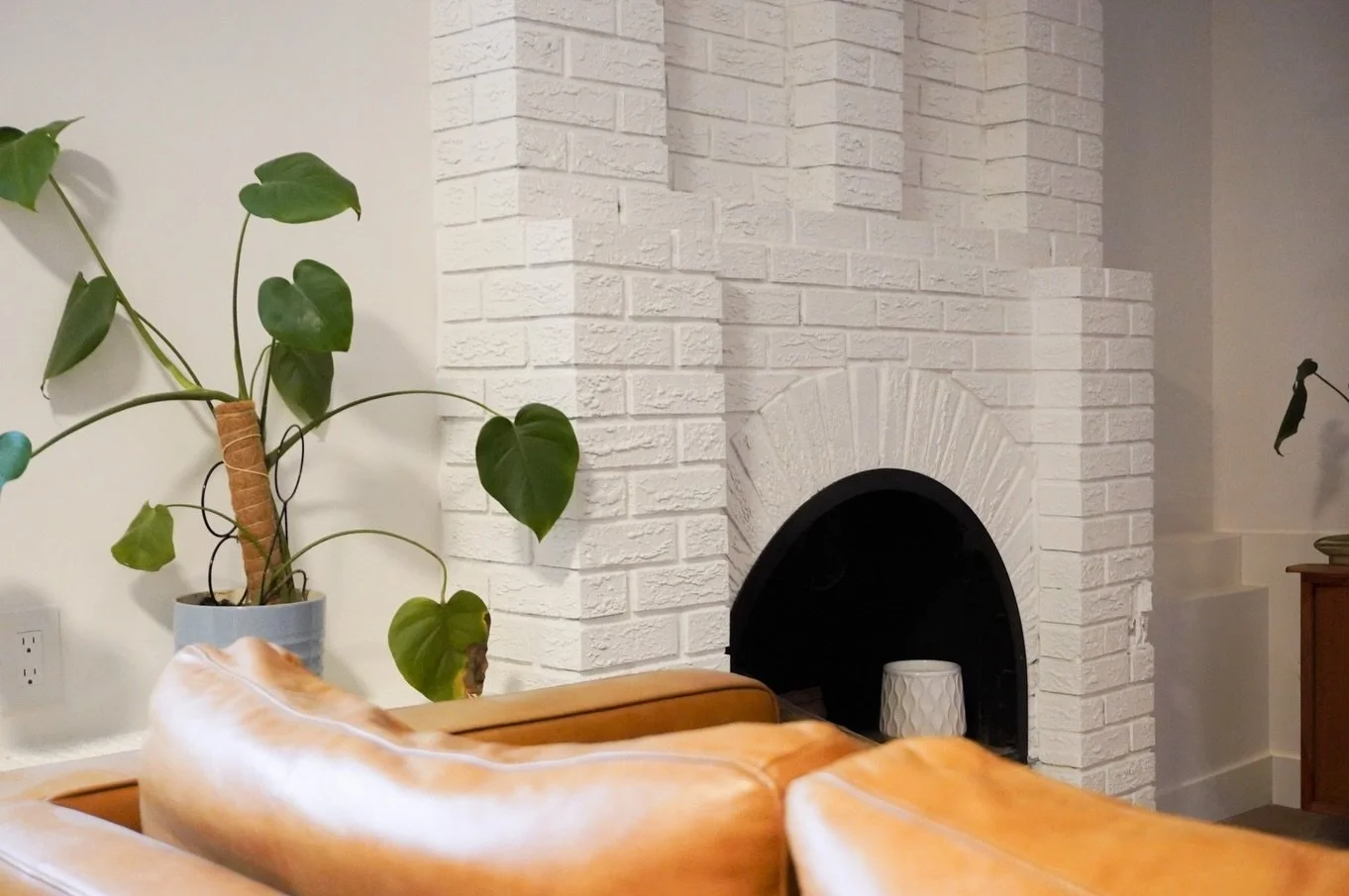 Painted brick in this sweet little off-the-kitchen sitting room, located behind Ryan and Sarah.

Keeping the homes design integrity but updating it to suit the owners taste more fully is exactly what a renovation should do!