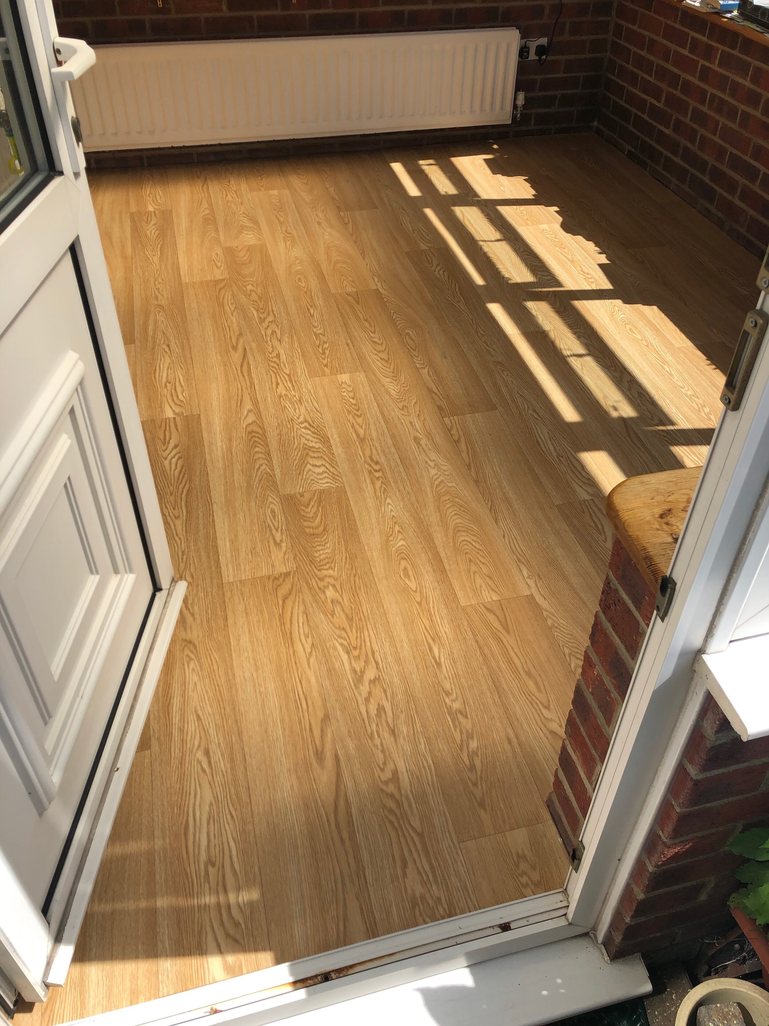 Domestic wood plank Vinyl fitted to a conservatory - A.T. Flooring - Swanage, Dorset.