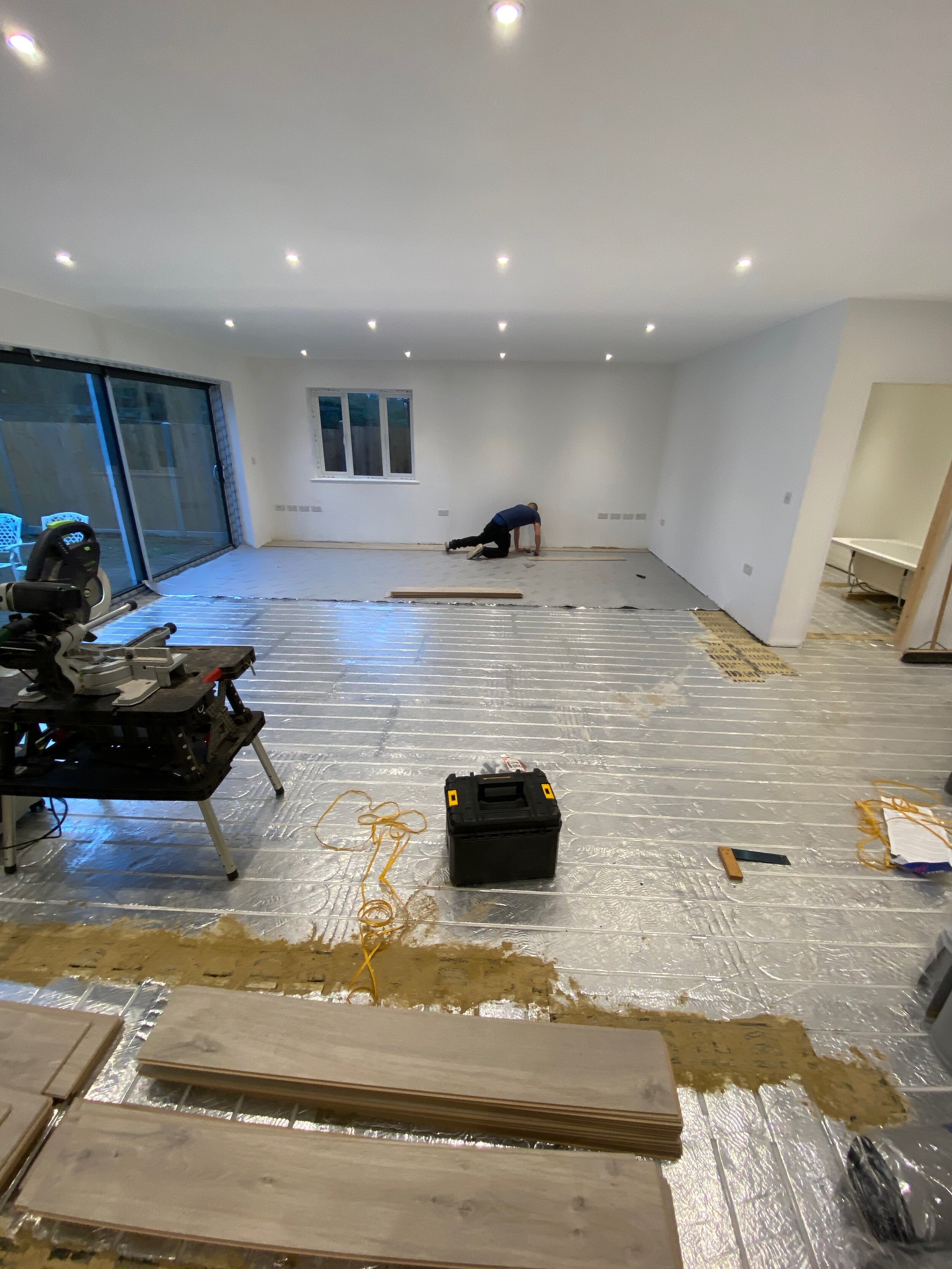 Quick-Step laminate flooring installed to the entire ground floor of this new build - kitchen/diner/family room, Bathroom, utility room, Bedroom and en-suit. - A.T. Flooring - Swanage, Dorset.