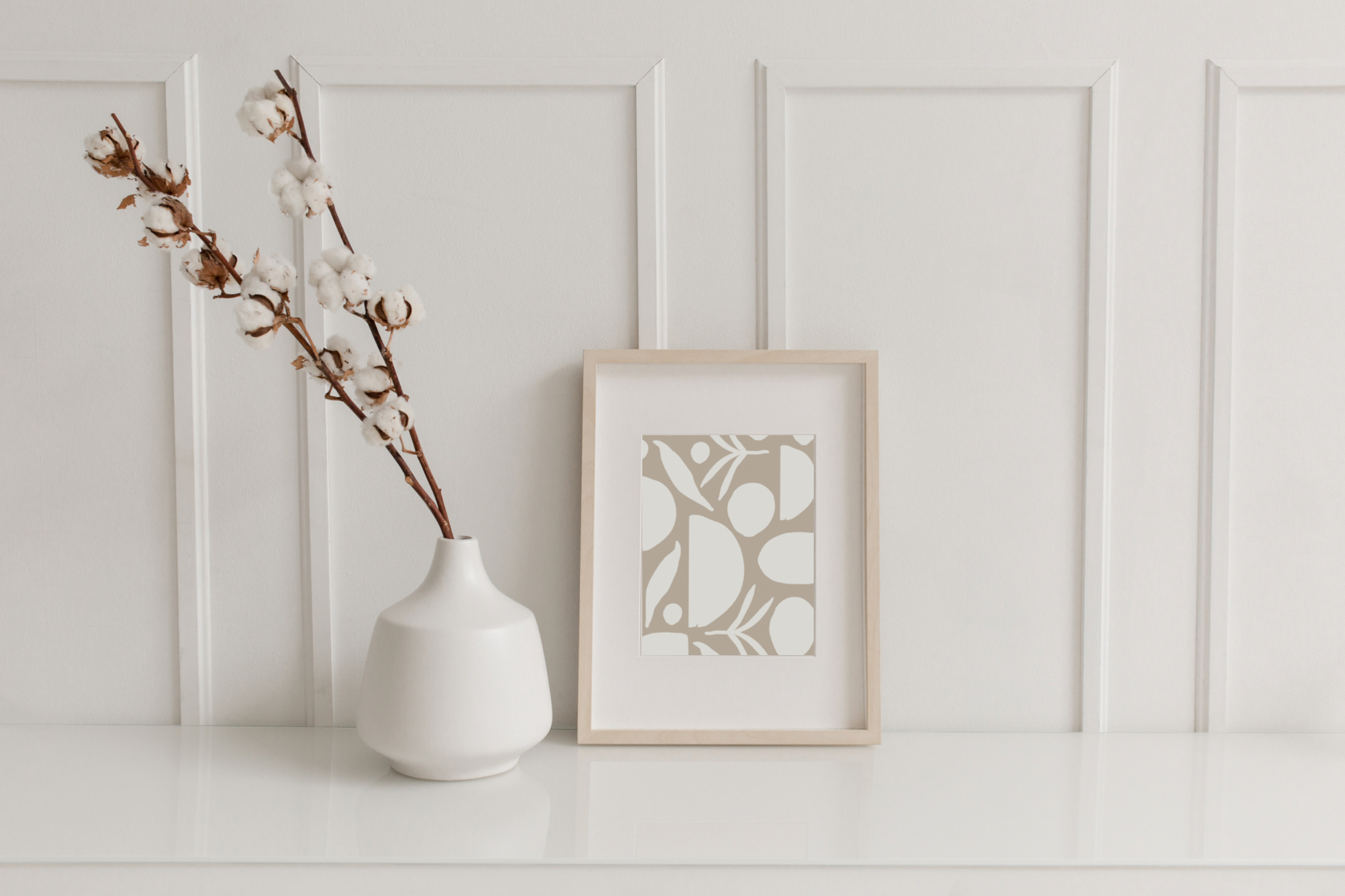 A framed plant pattern next to a floral arrangement in a vase, creating a regulated and comforting aesthetic for trauma counseling in Denver.