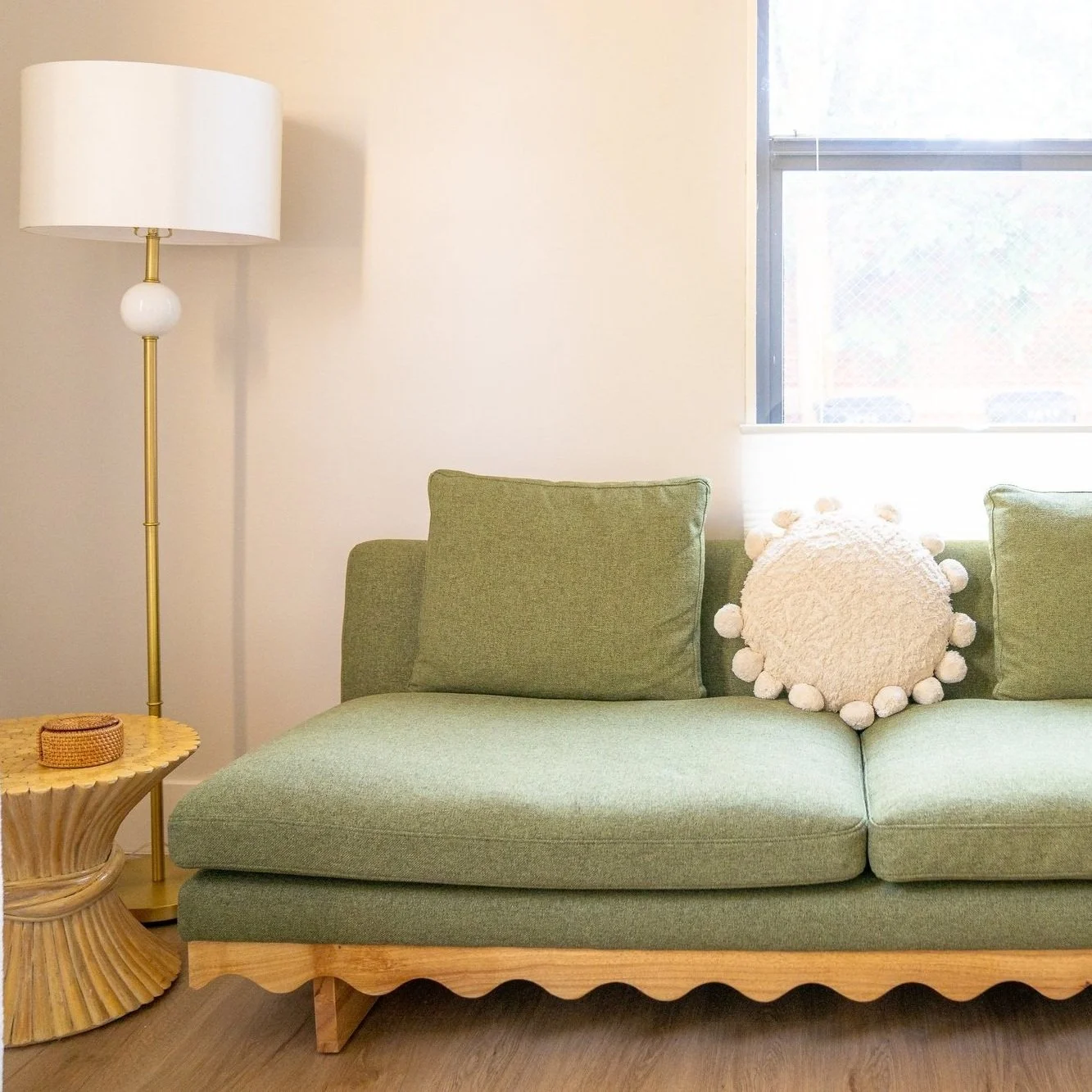 A green therapy couch with a round cream pillow, designed for comfort during intensive EMDR processing.