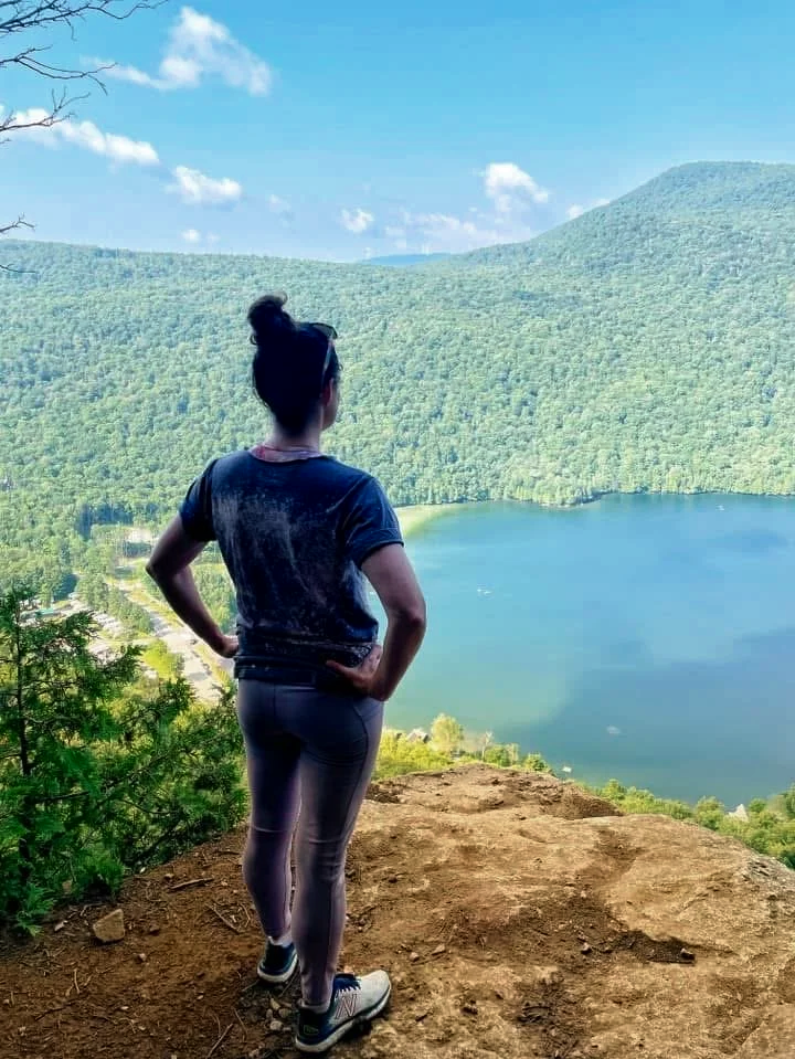 Lisa Kern overlooking a mountain lake, symbolizing self-discovery after major life transitions and people pleasing.