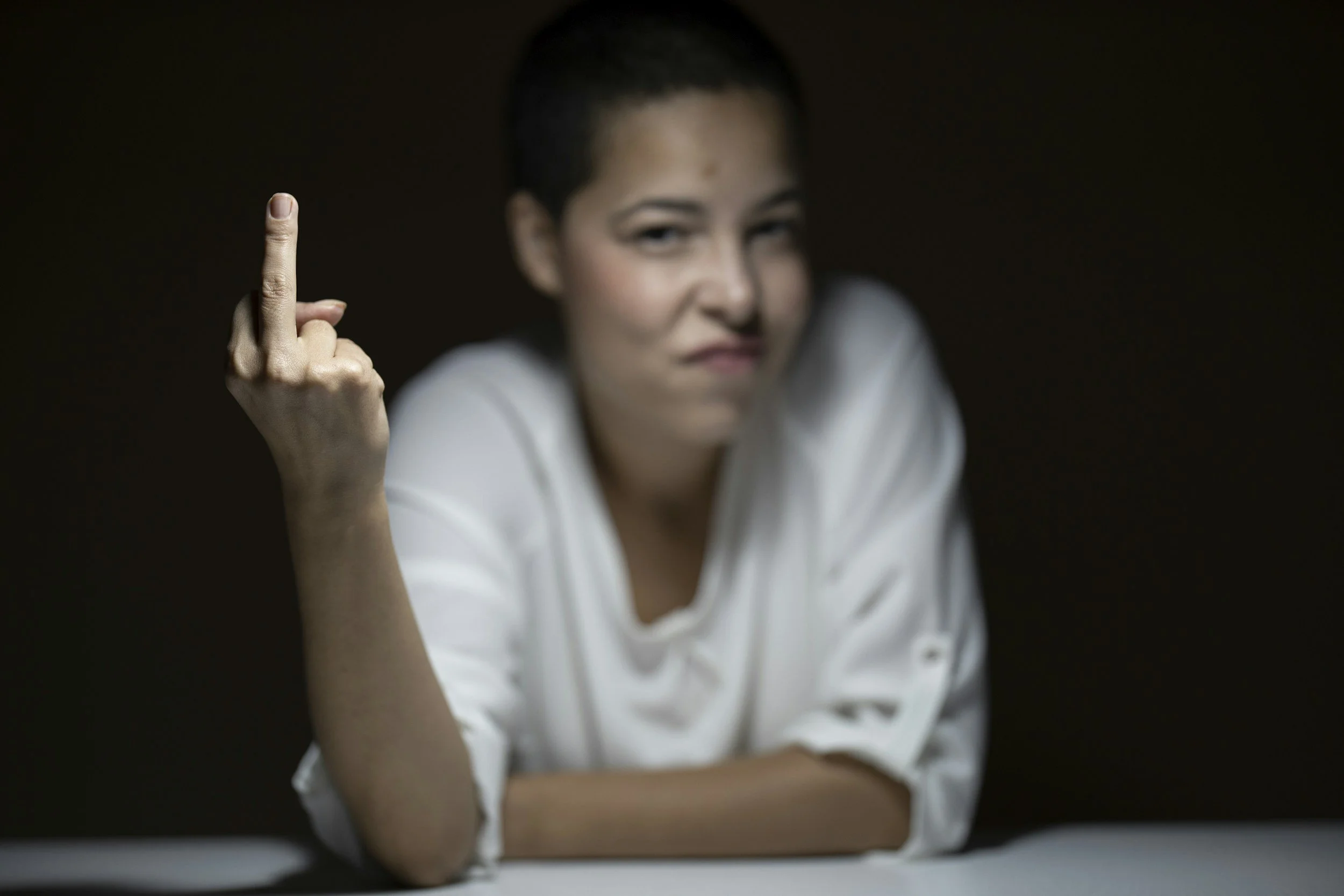 Woman expressing hidden anger and frustration while exploring the connection to anxiety during holistic therapy