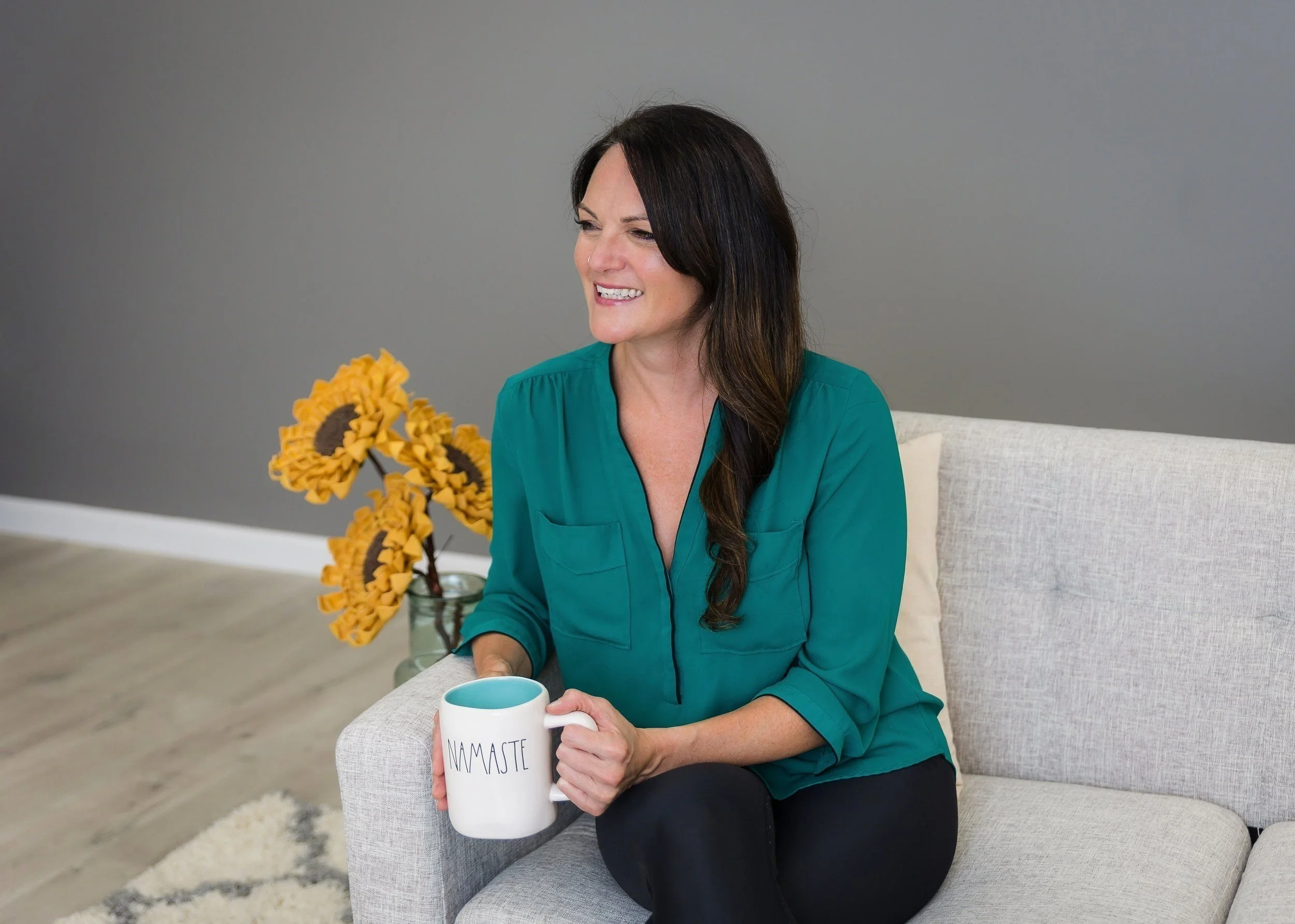 Lisa Kern Reiki Master and Holistic Therapist holding a coffee mug while smiling and connecting with readers