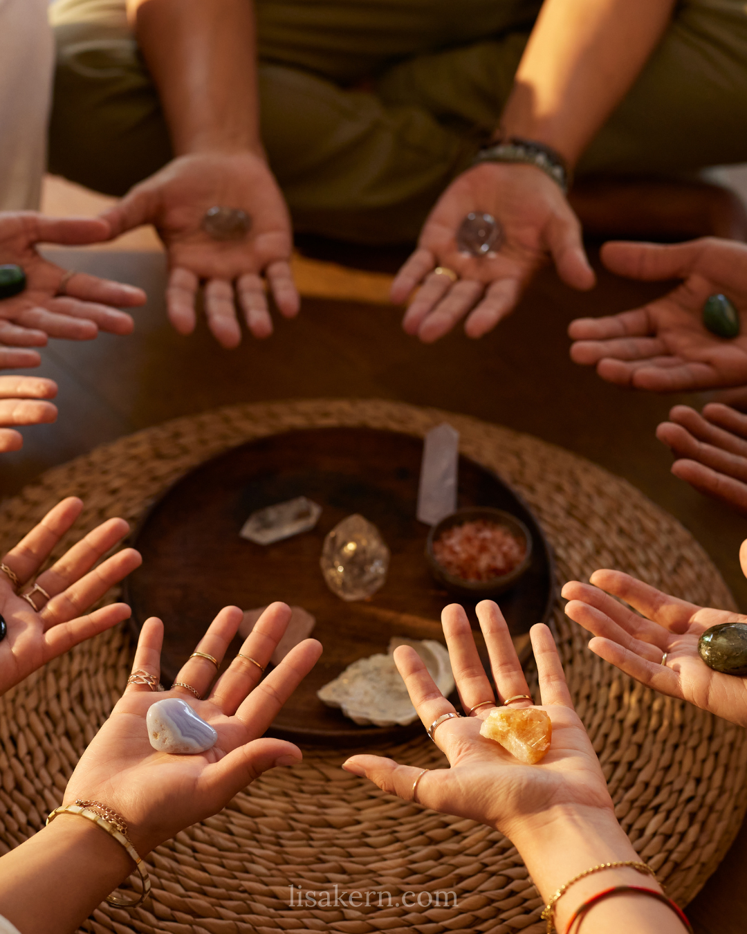 Group of women participating in a calming moon circle ritual, holding crystals and practicing holistic healing together.