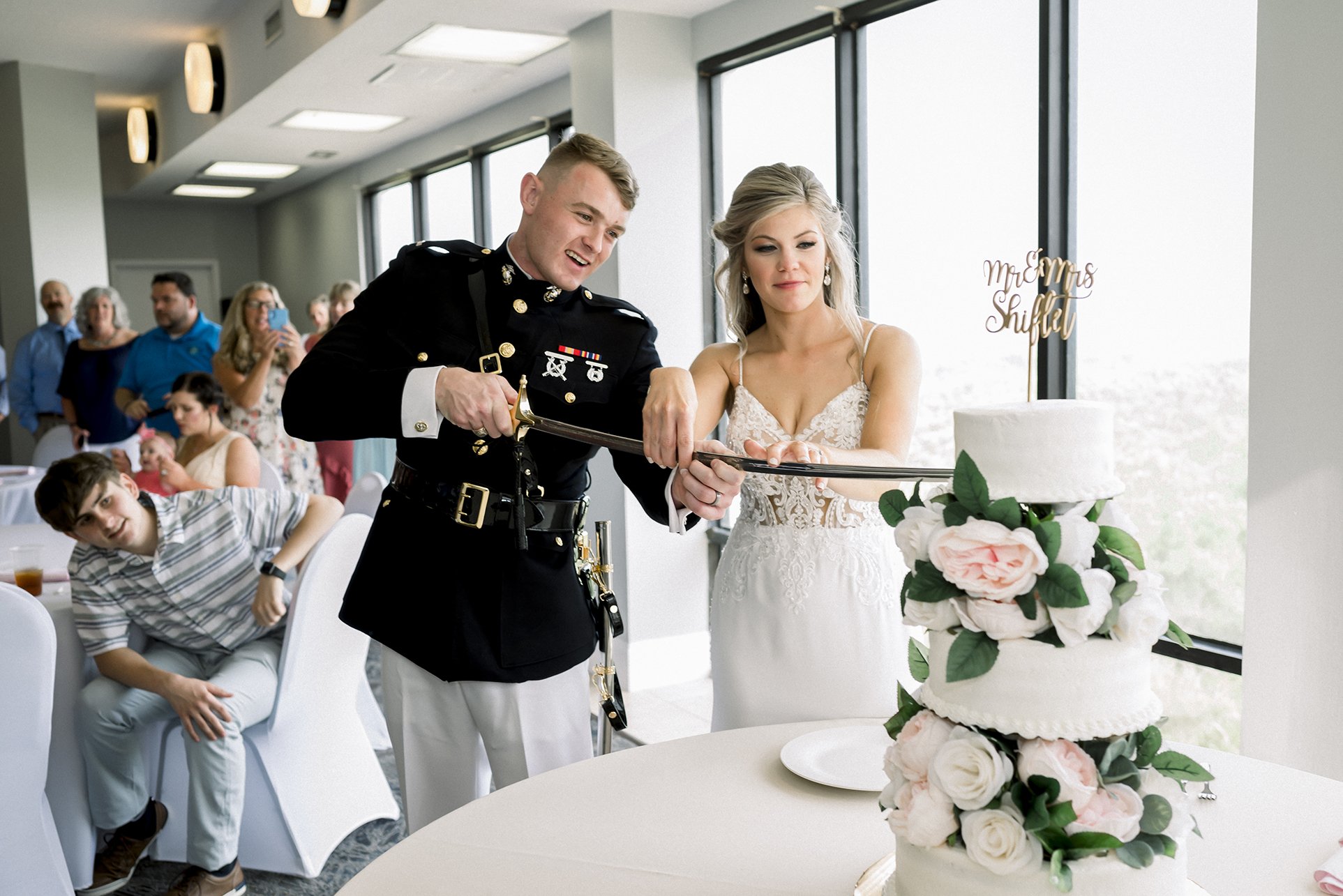 Wedding cake cutting with marine sword