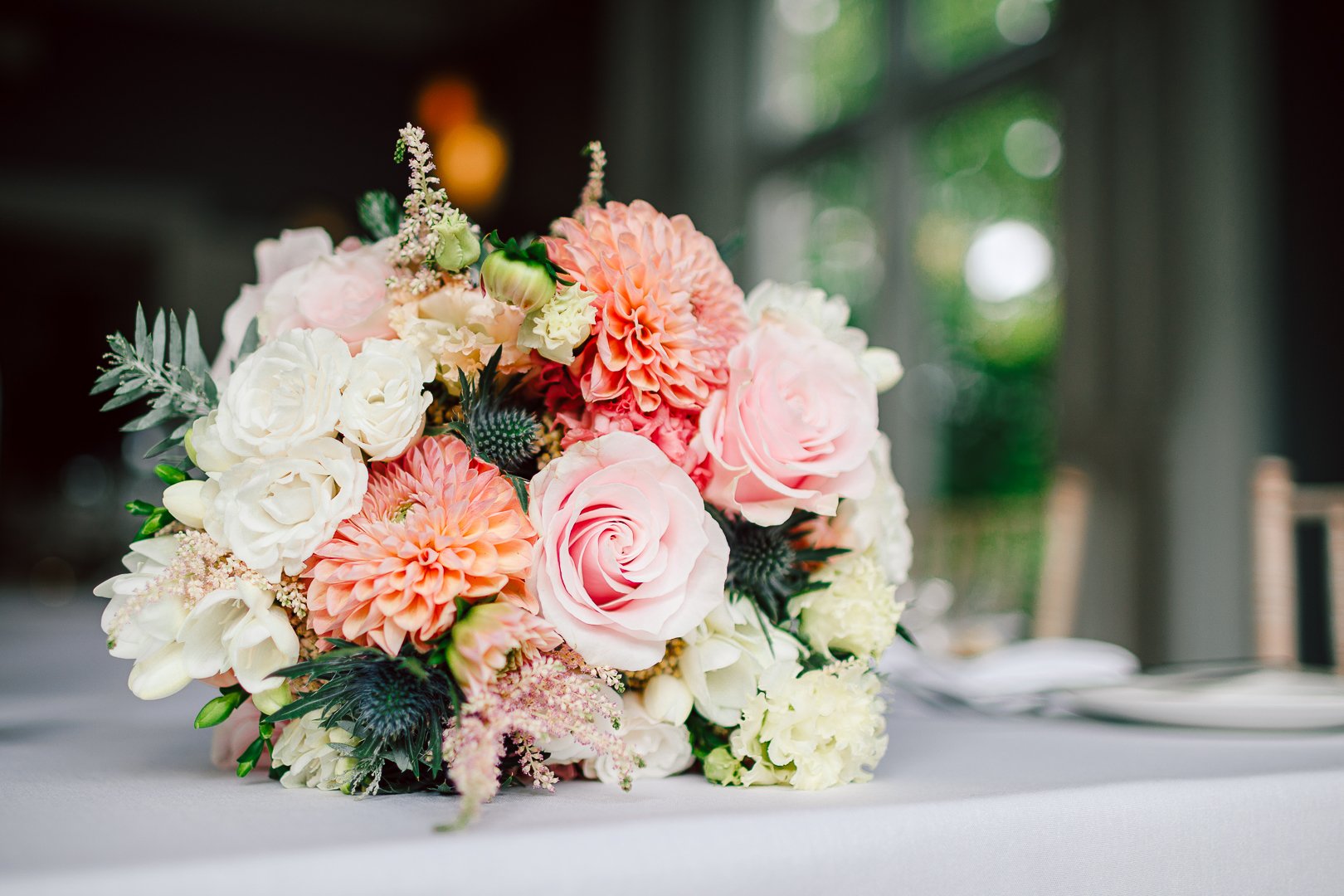 brides pink and pastel summer bouquet on table at Didsbury House Hotel