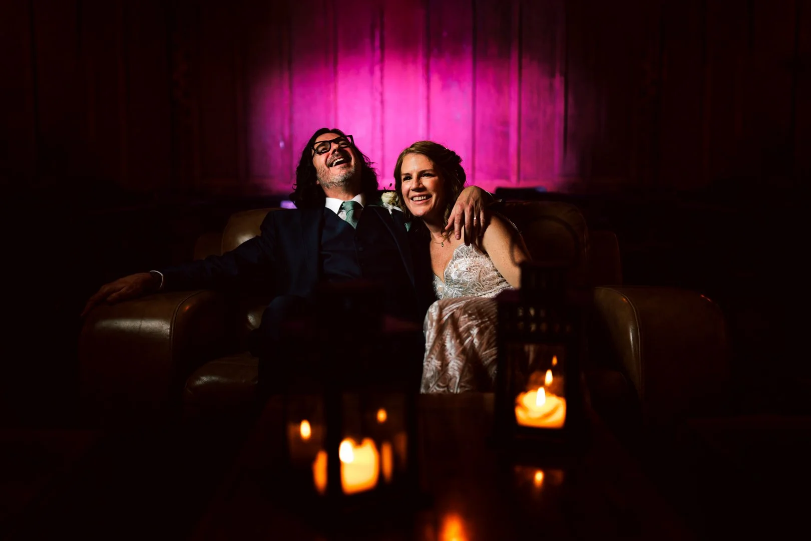 Bride and Groom laughing during relaxed portrait photography on their wedding day at Victoria Warehouse in Manchester