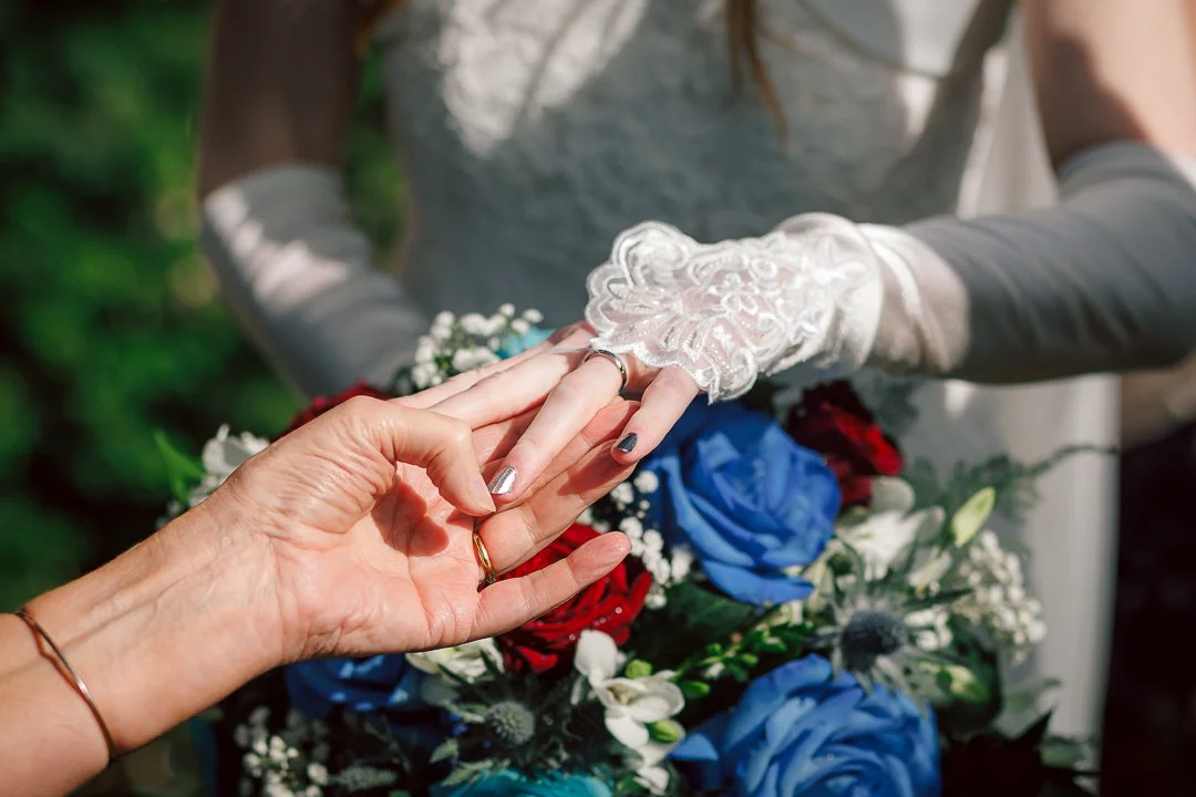 Bride shows off her wedding ring to guests