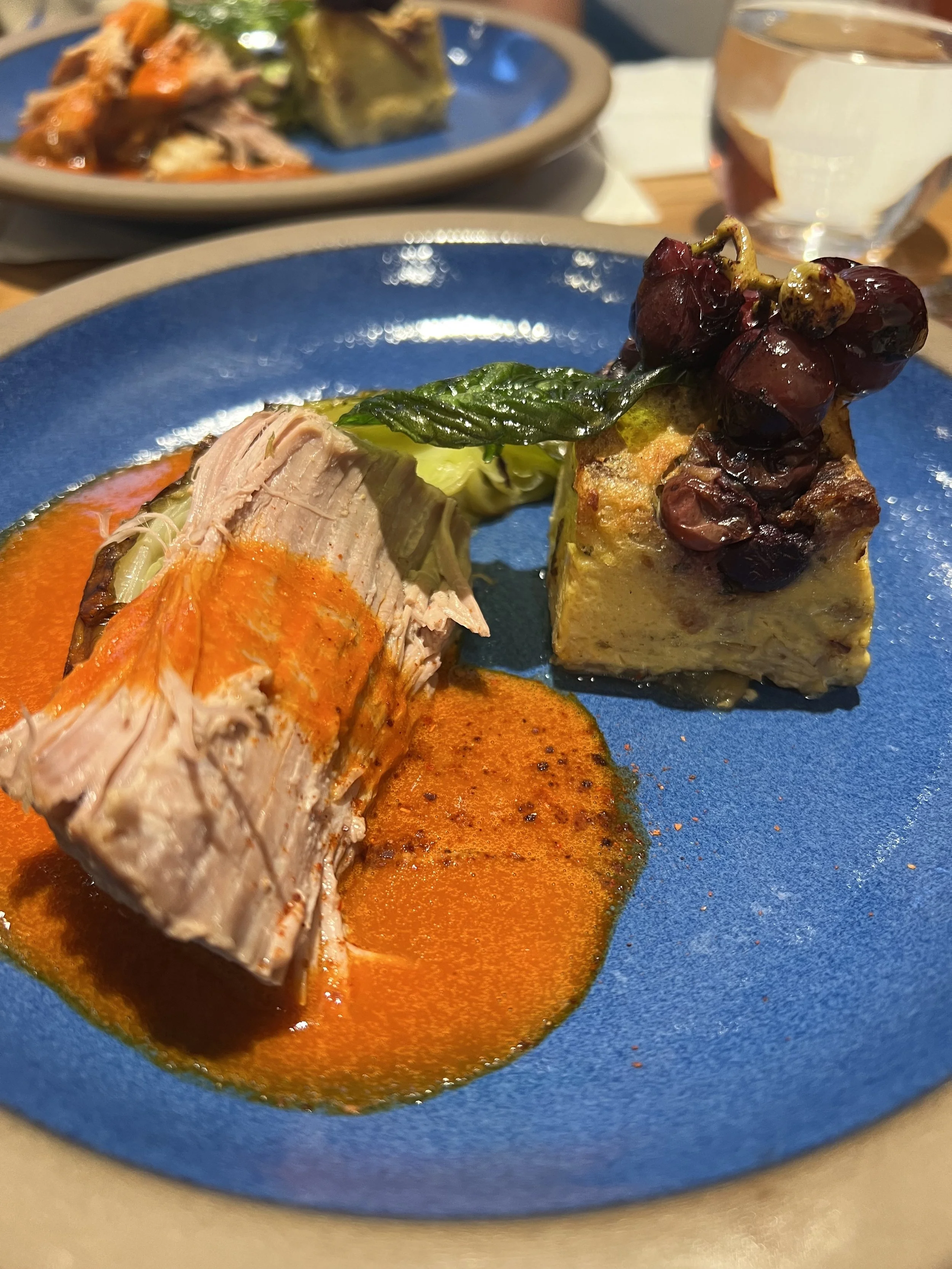 Braised Pork in Jimmy Nardello Cream with Concord Grape pain perdu by Chef Courtney Sproule.