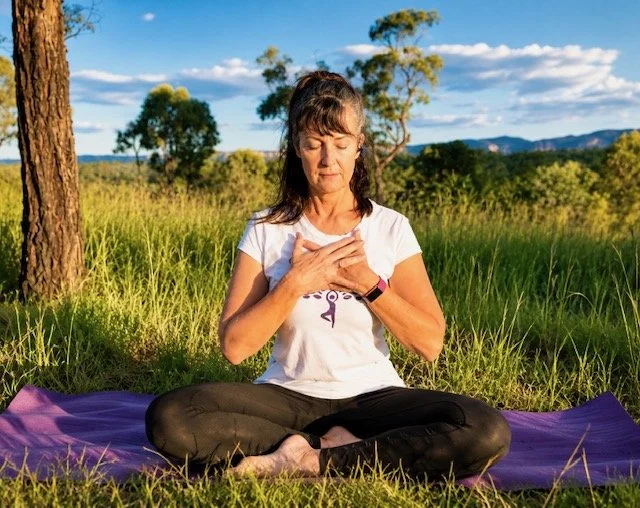 Jodie meditating and yoga breathing out in nature