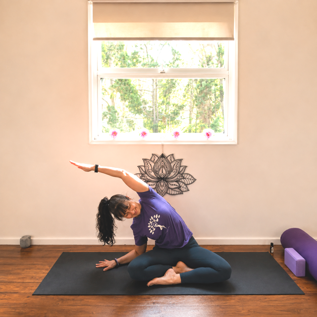 Jodie in a seated side stretch for neck, shoulder, and back
