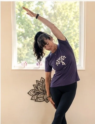 Jodie in a standing gentle side stretch for back health