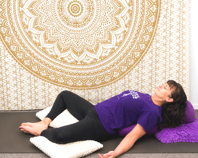 Jodie from Kevala Health is practicing the restorative butterfly yoga pose to deeply relax