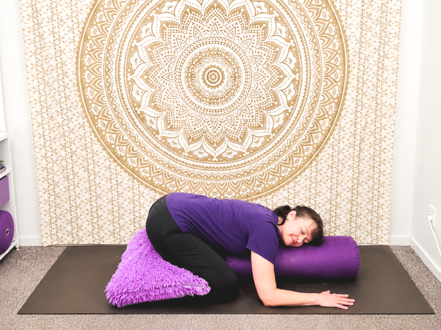 Jodie in the gentle yoga pose called child pose