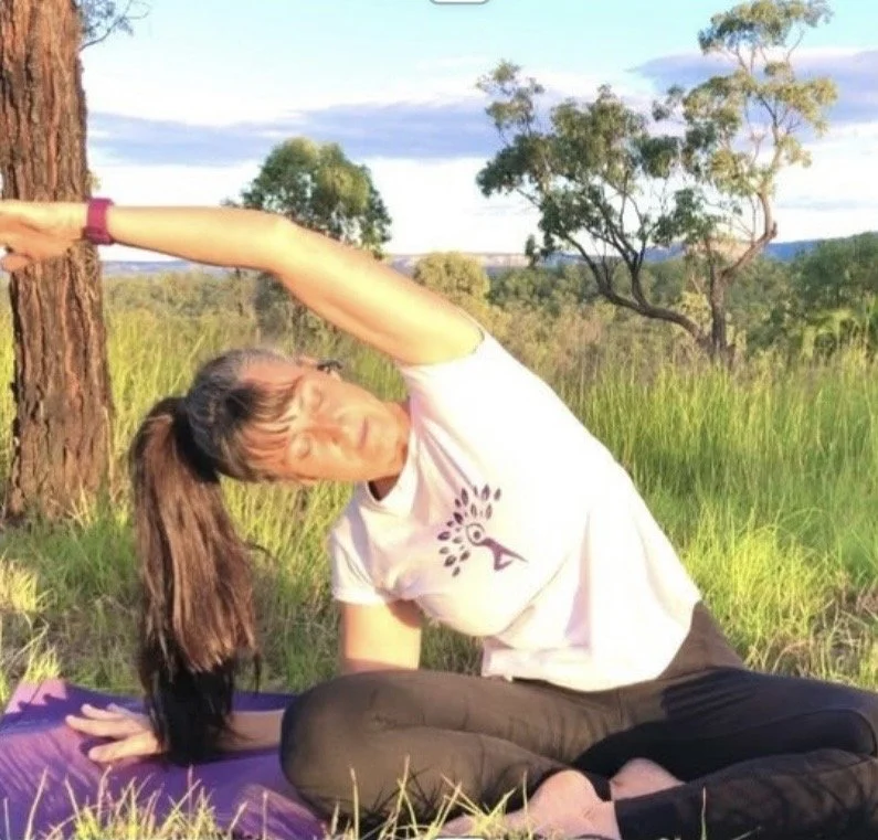 Jodie demonstrating a seated beginner side stretch outside.jpg