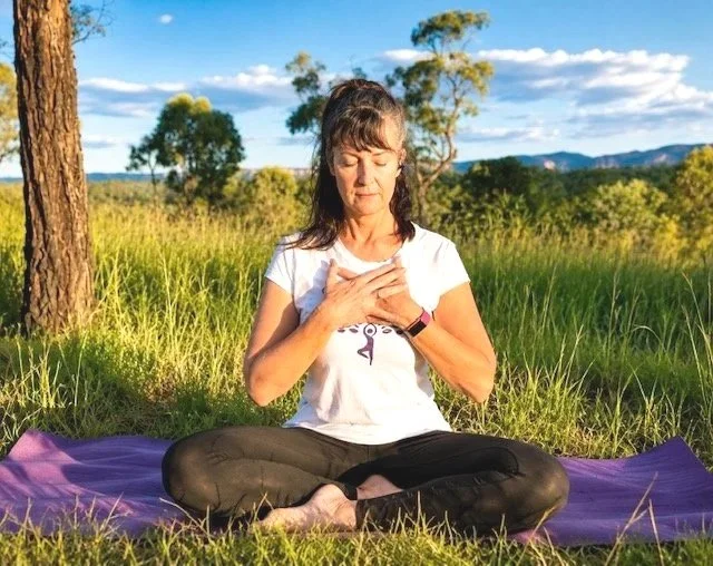 Jodie meditating outside in nature