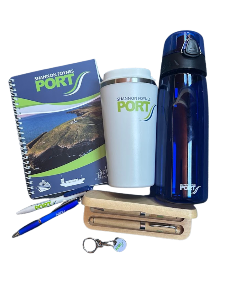 Collection of promotional items including a spiral notebook, pen, drinking mugs, a blue water bottle, a wooden pencil case with pens inside, and a keychain, all branded with 'Shannon Foynes Port'