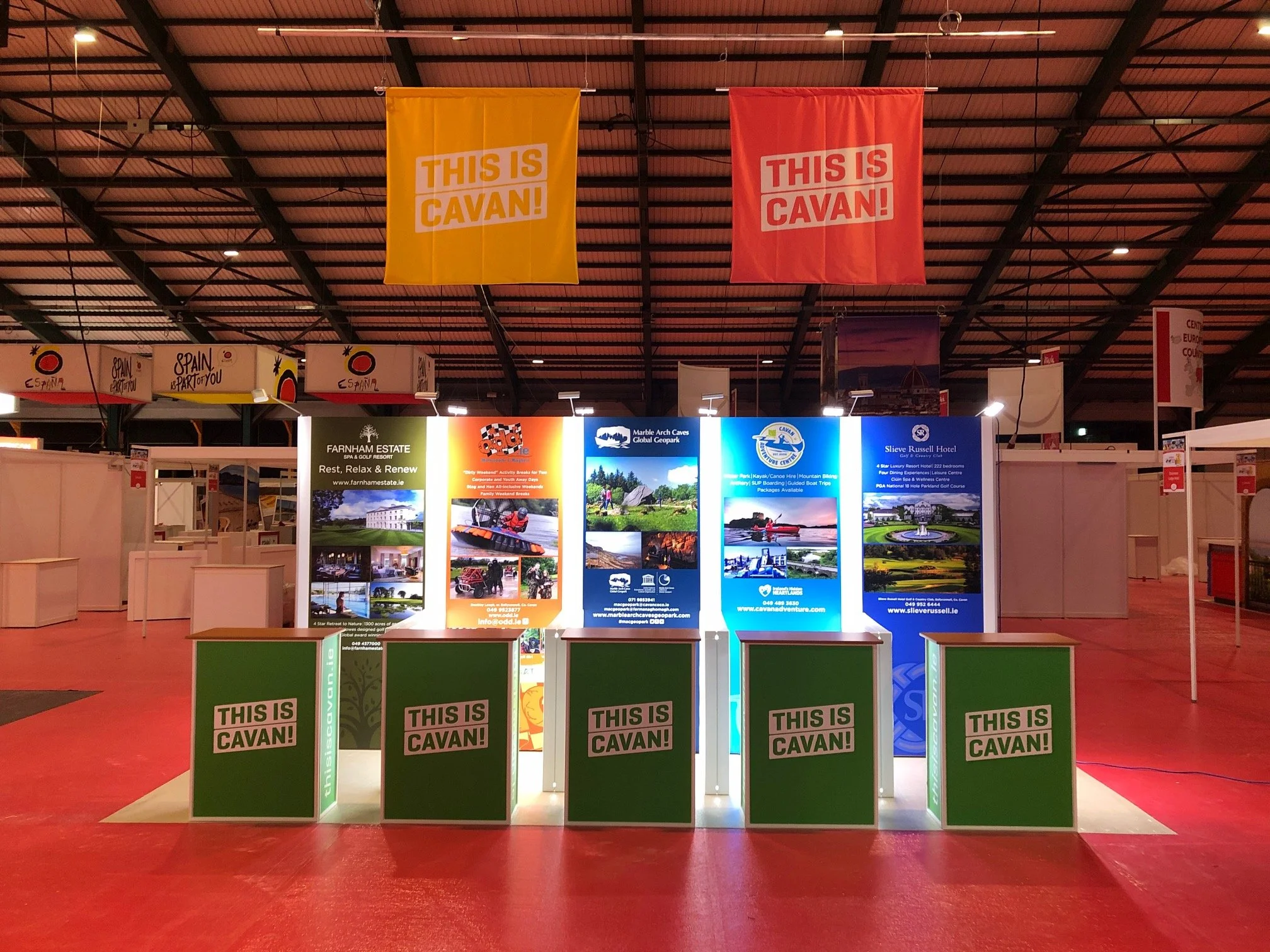 Trade show booth with promotional banners and counters displaying 'This is Cavan!' in an exhibition hall.