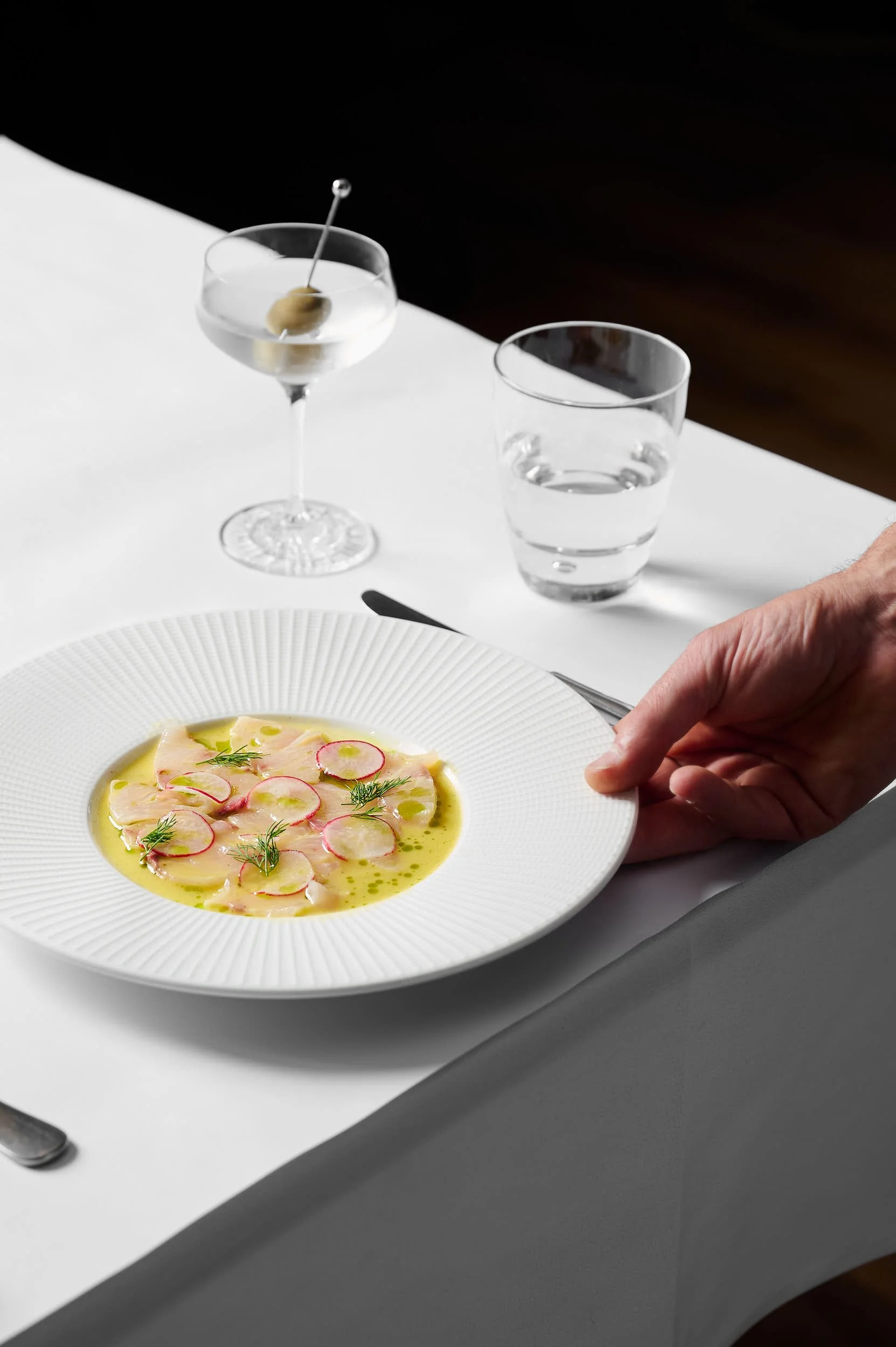 Beautiful hospitality photography: kingfish crudo and martini on table by Charlotte Orr, photographer based in Melbourne, Australia