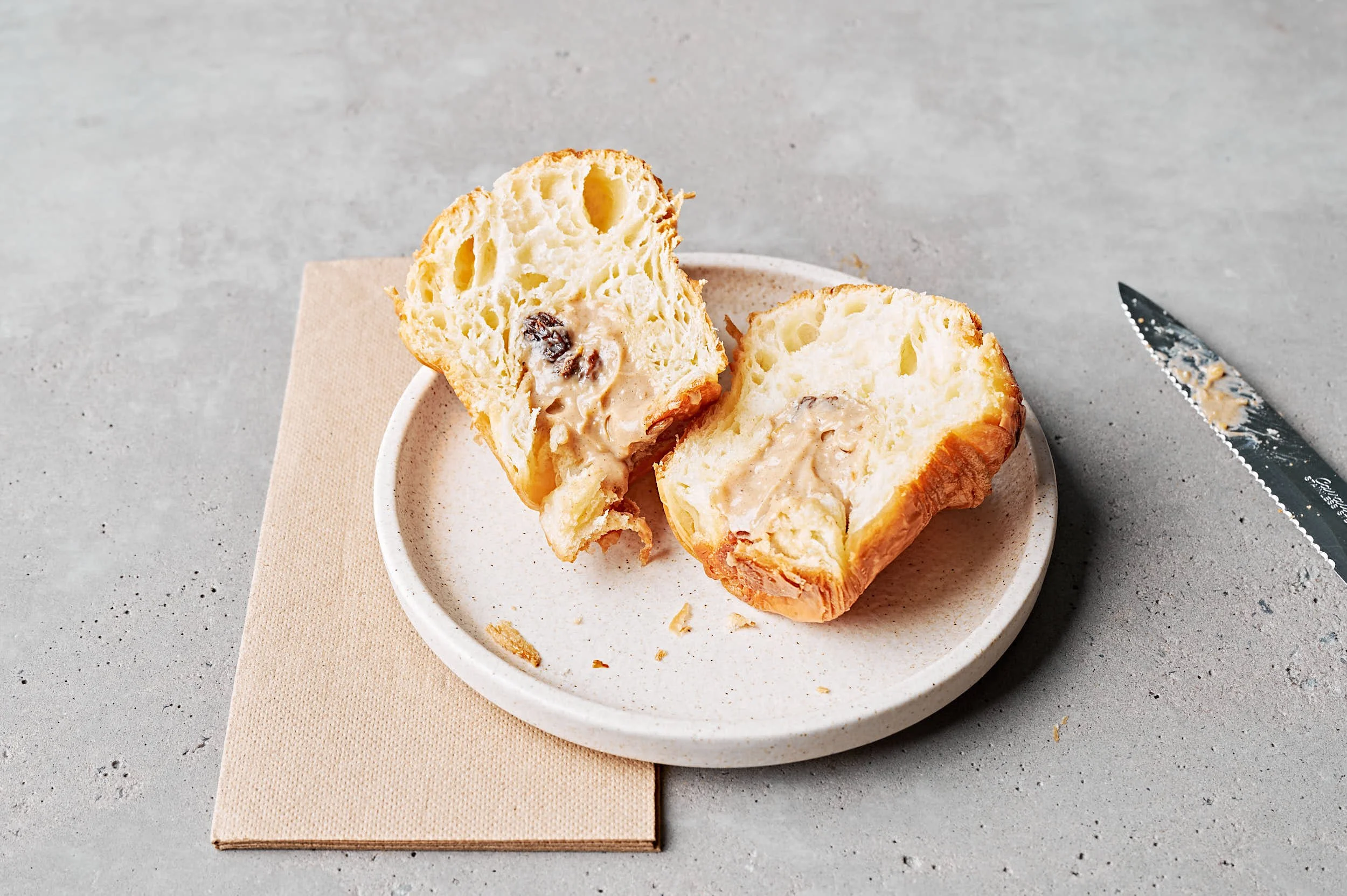 Editorial food photography: hot cross cruffin cut open on plate by Melbourne food photographer Charlotte Orr
