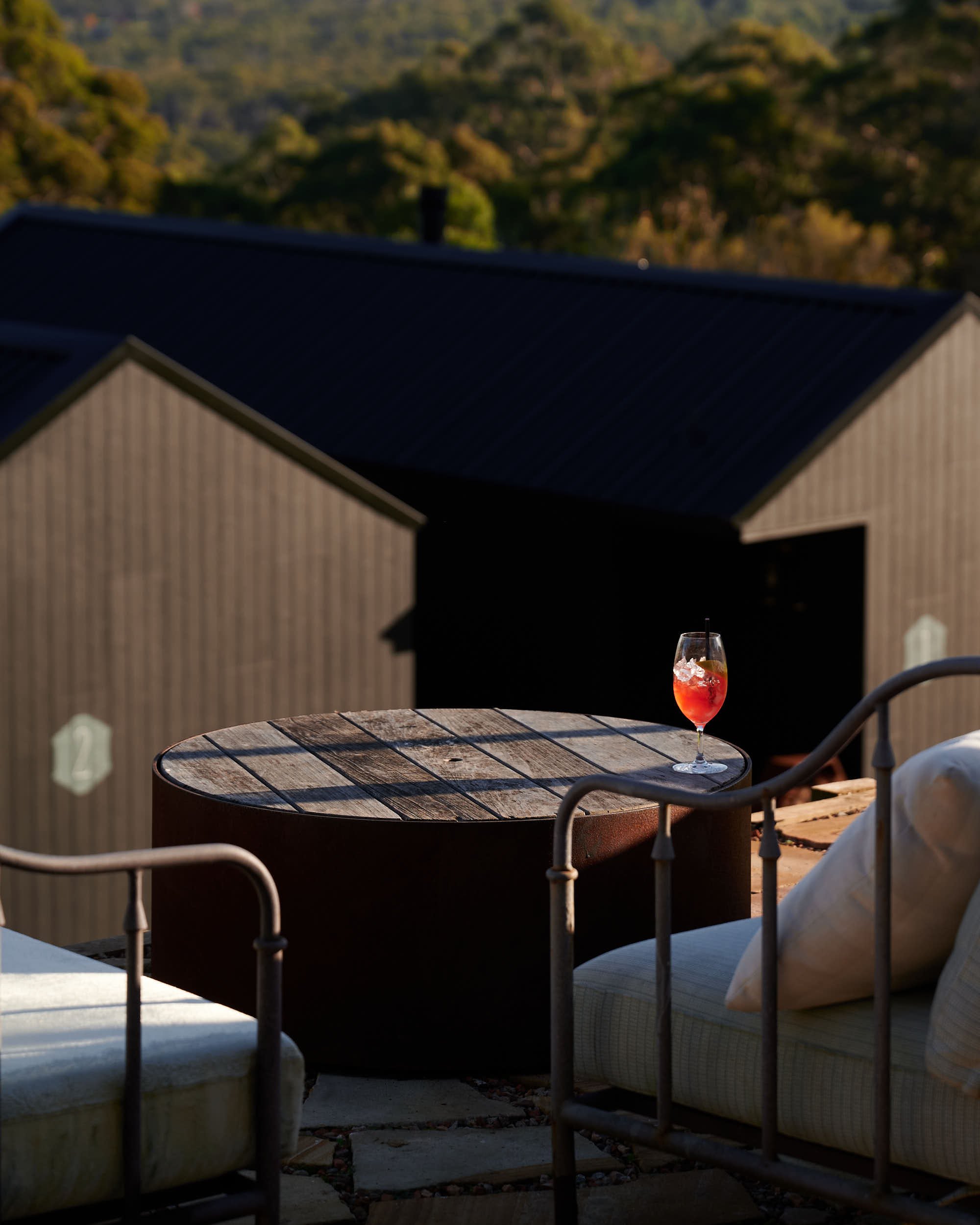 Beautiful hospitality photography: aperol spritz cocktail on outdoor table by Charlotte Orr, photographer based in Melbourne, Australia