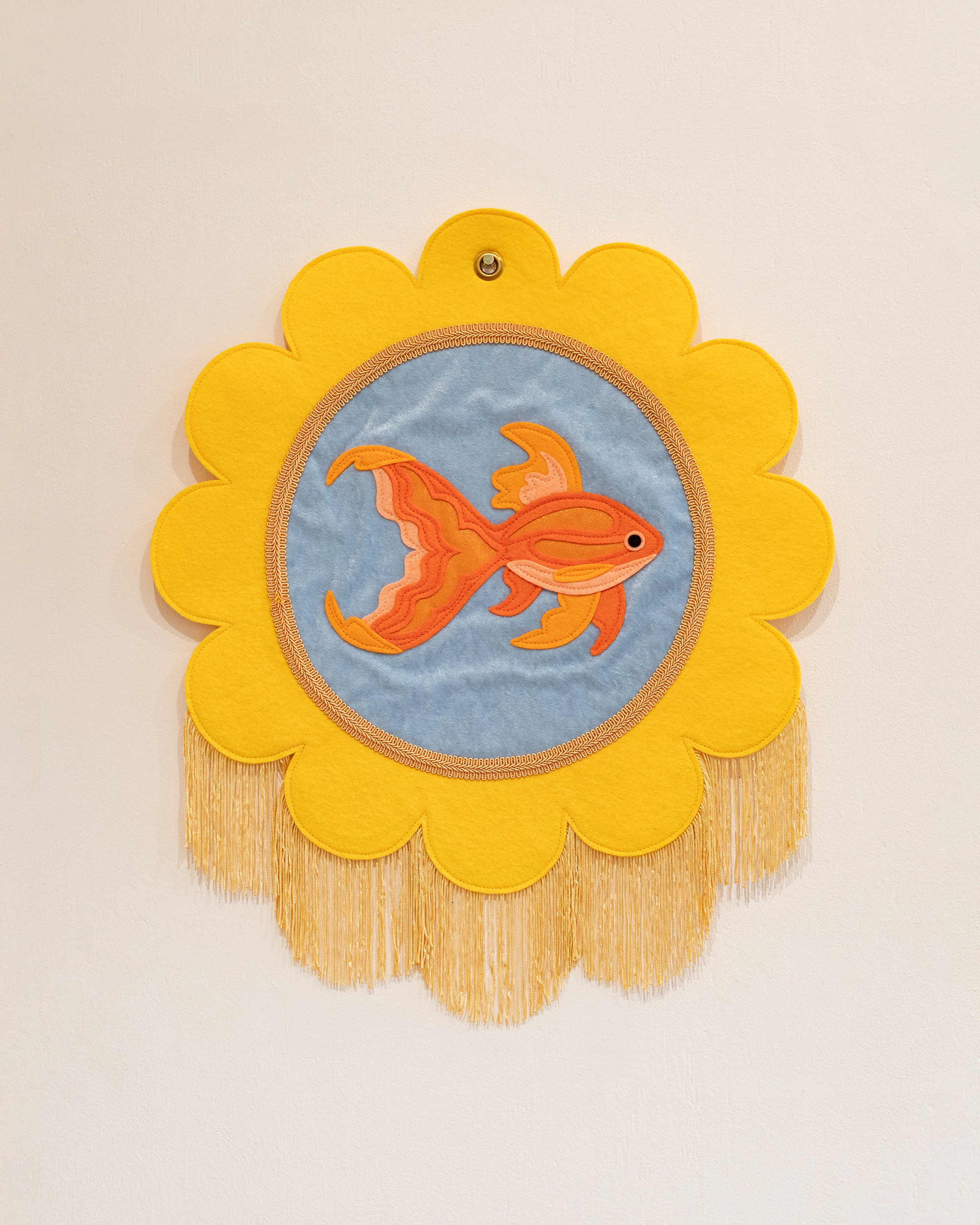 "Goldfish" (2025) wool-blend felt, cotton, velvet, braid trim, thread, brass grommet, 18"x18"