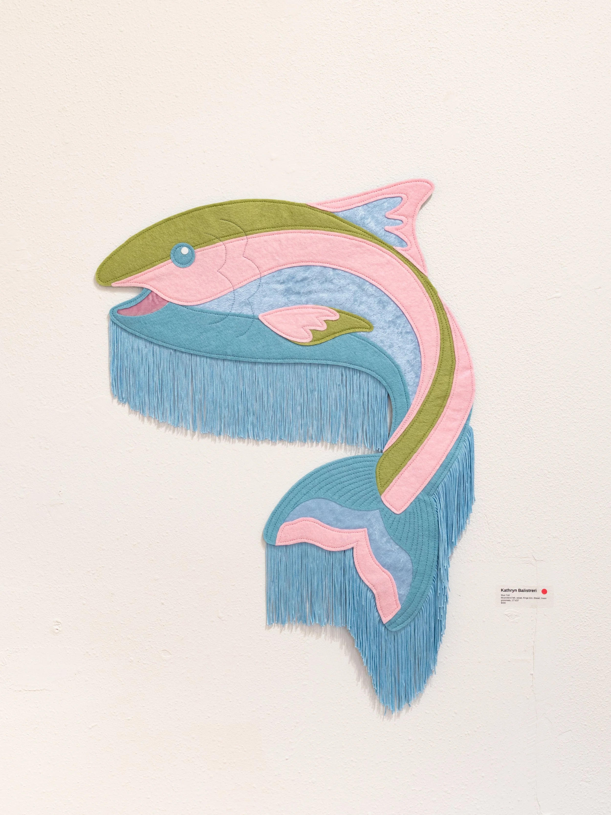 "Blue Fish" (2025) wool-blend felt, velvet, fringe trim, thread, brass grommets