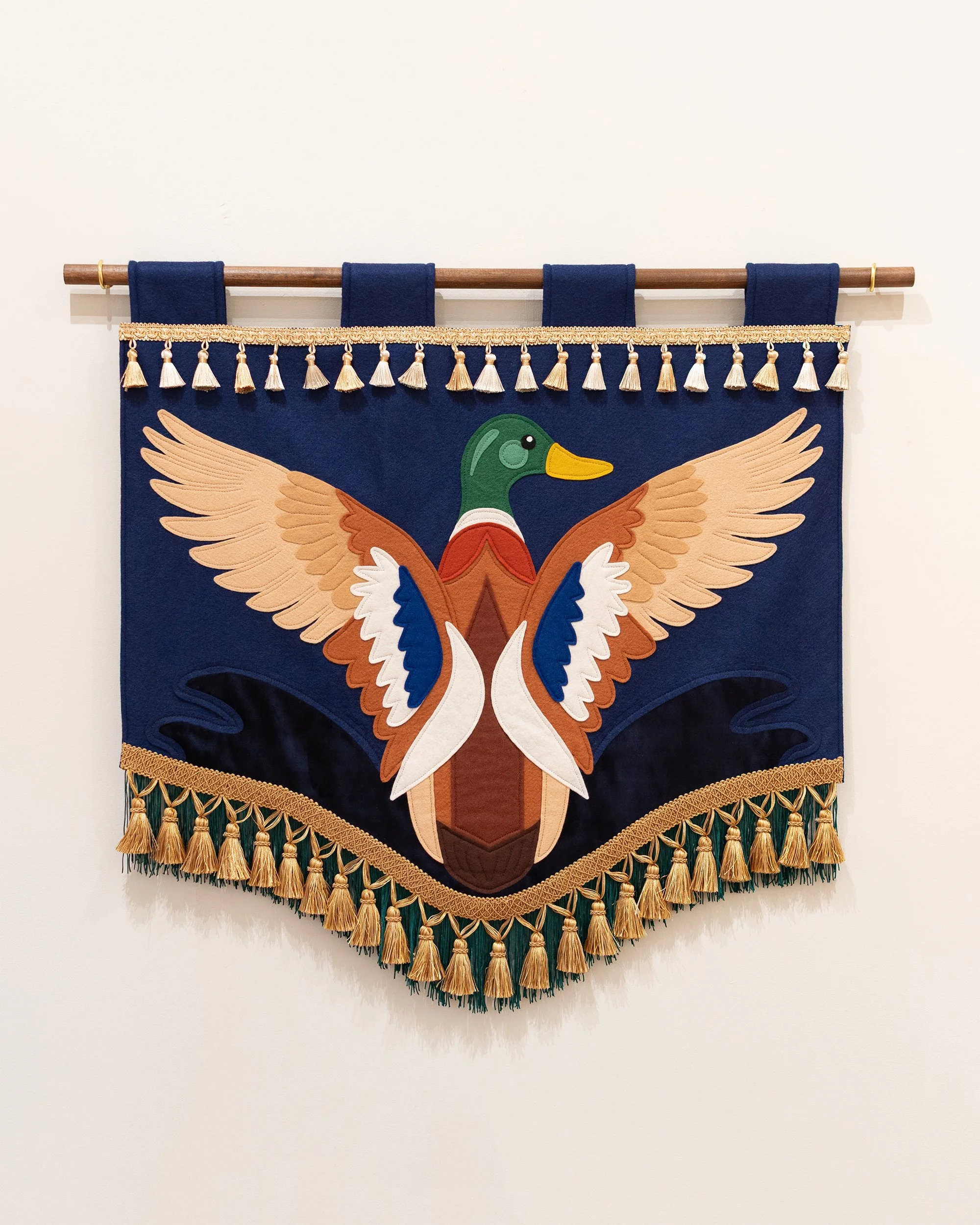 "Mallard" (2025) wool-blend felt, velvet, fringe & tassel trim, thread, bamboo dowel rod, 28”x27” (32” wide with rod)
