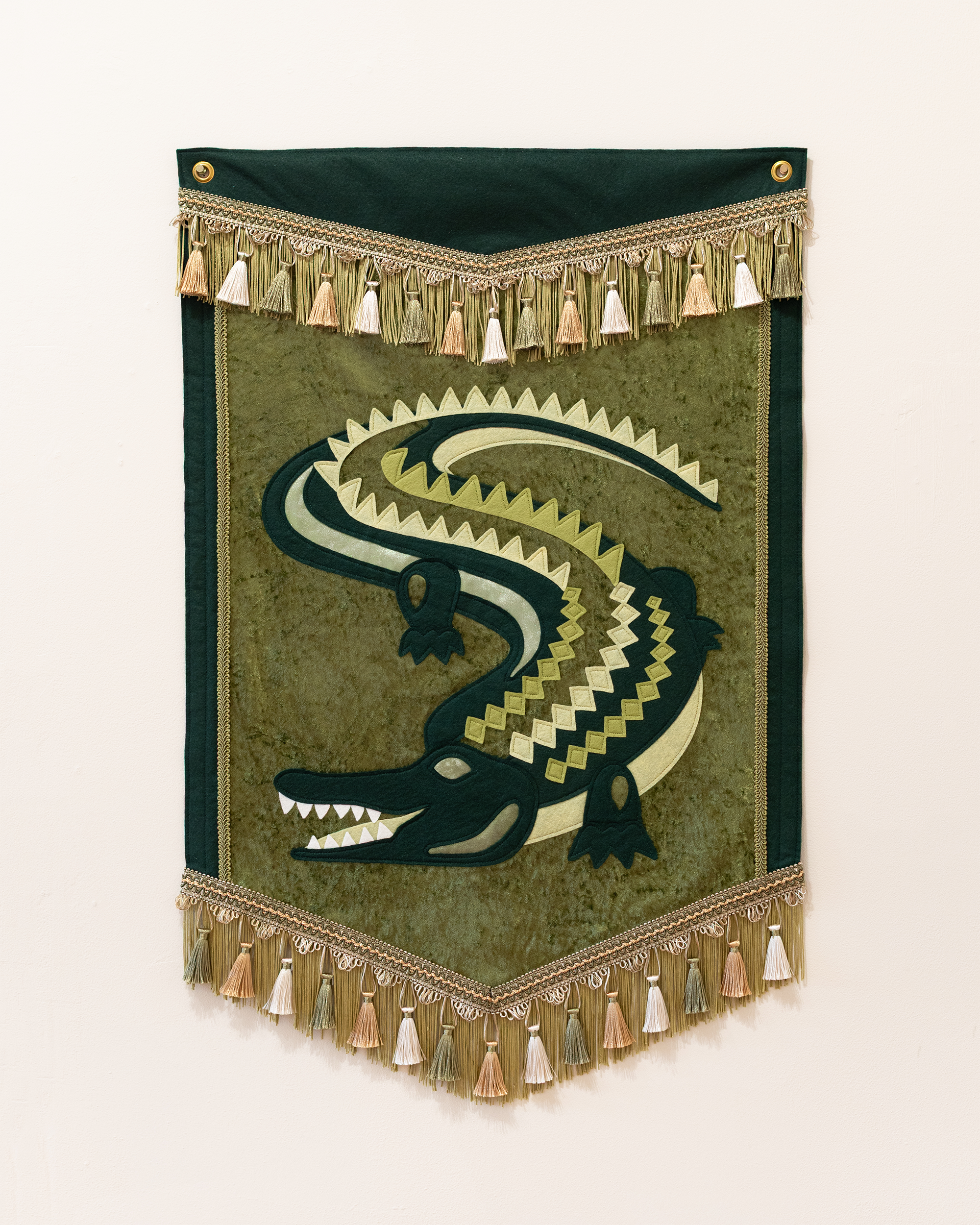 "Alligator Alligator" (2025) wool-blend felt, velvet, fringe & tassel trim, thread, brass grommets, 23.5”x36”