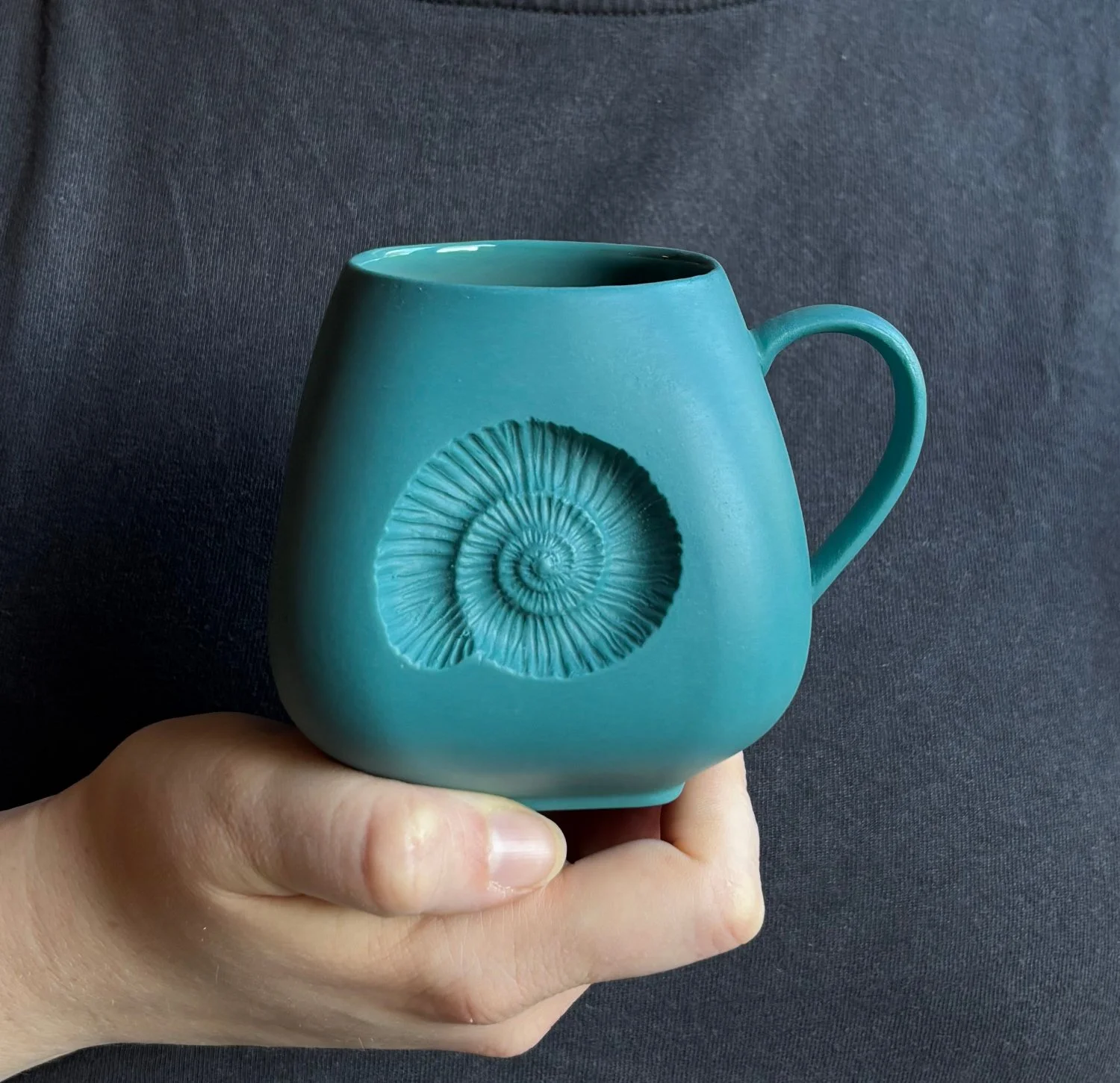 Ammonite Large mug held Teal.jpg