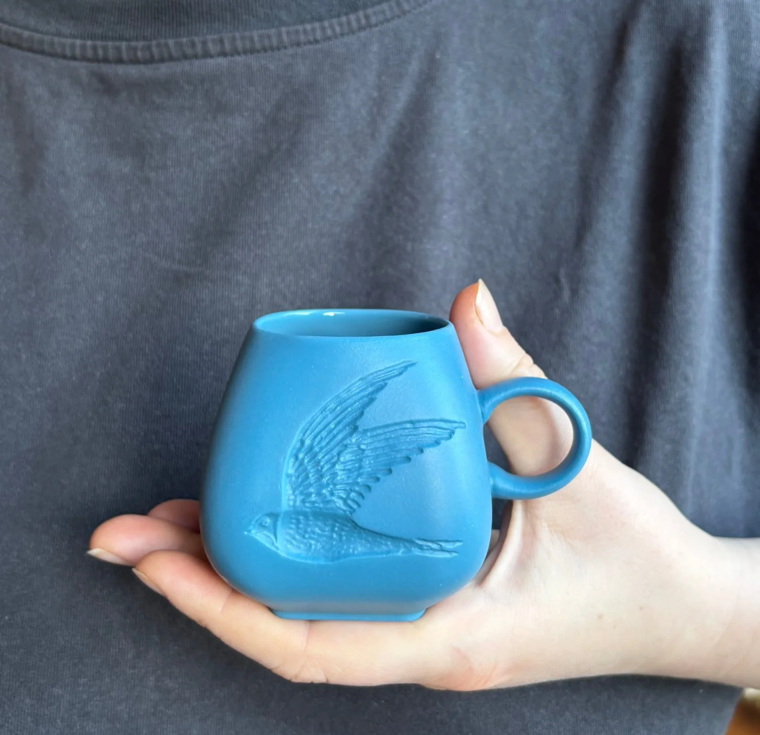 Swift_espresso_mug_teal_green_held.jpg