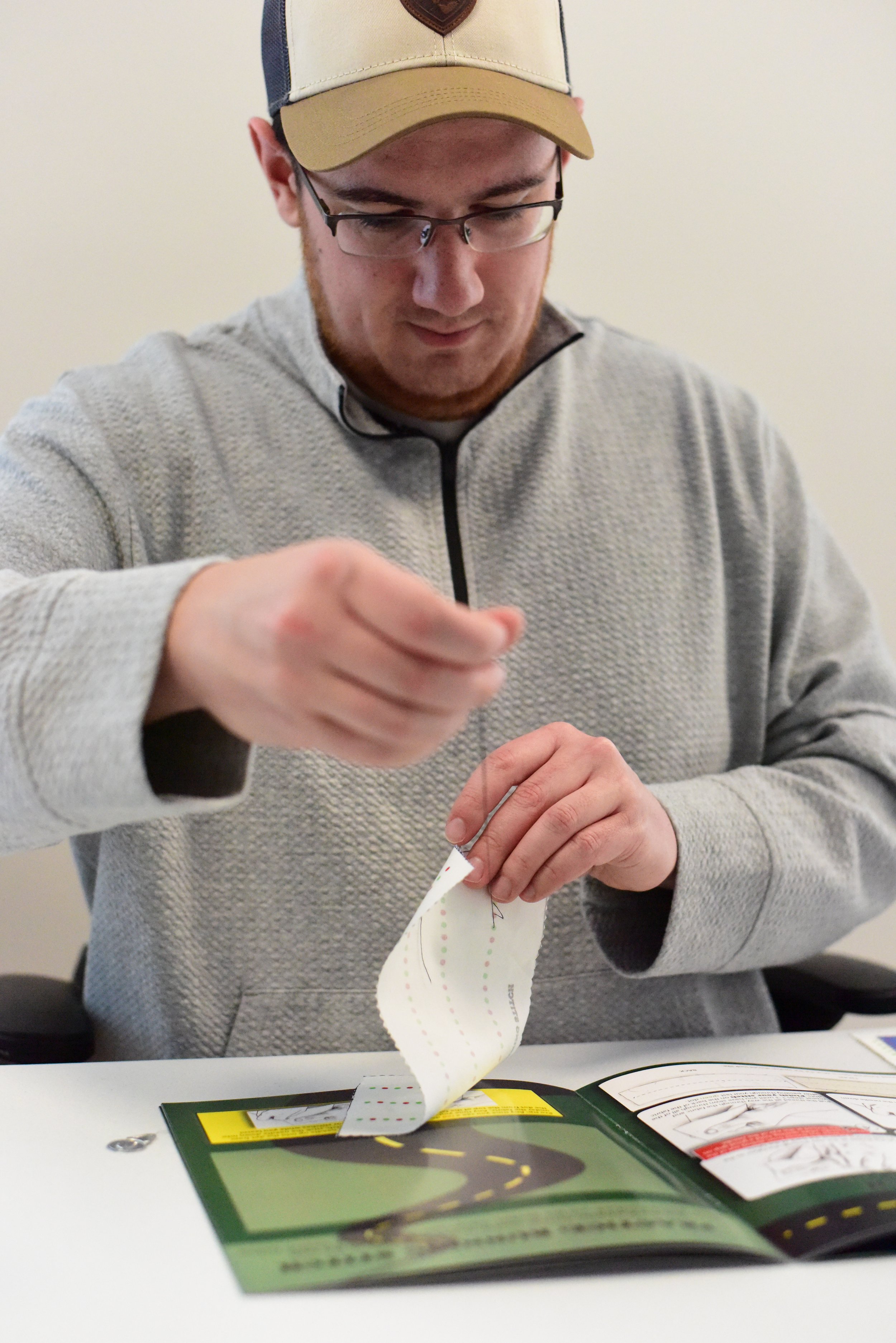 Man is working on projects in "Thready, Set, Sew!"