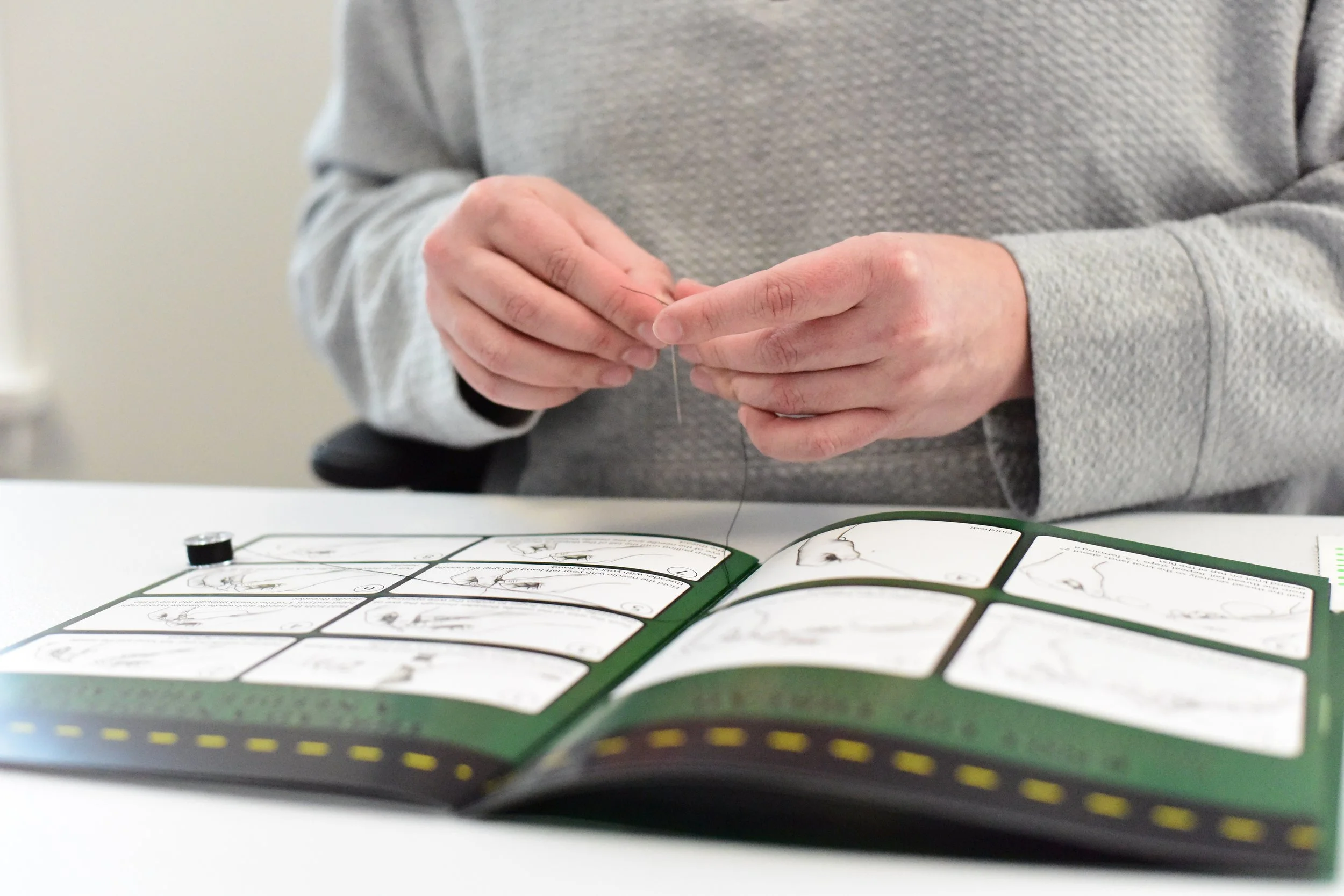 Close up image of hands demonstrates how "Thready, Set, Sew!" is used.