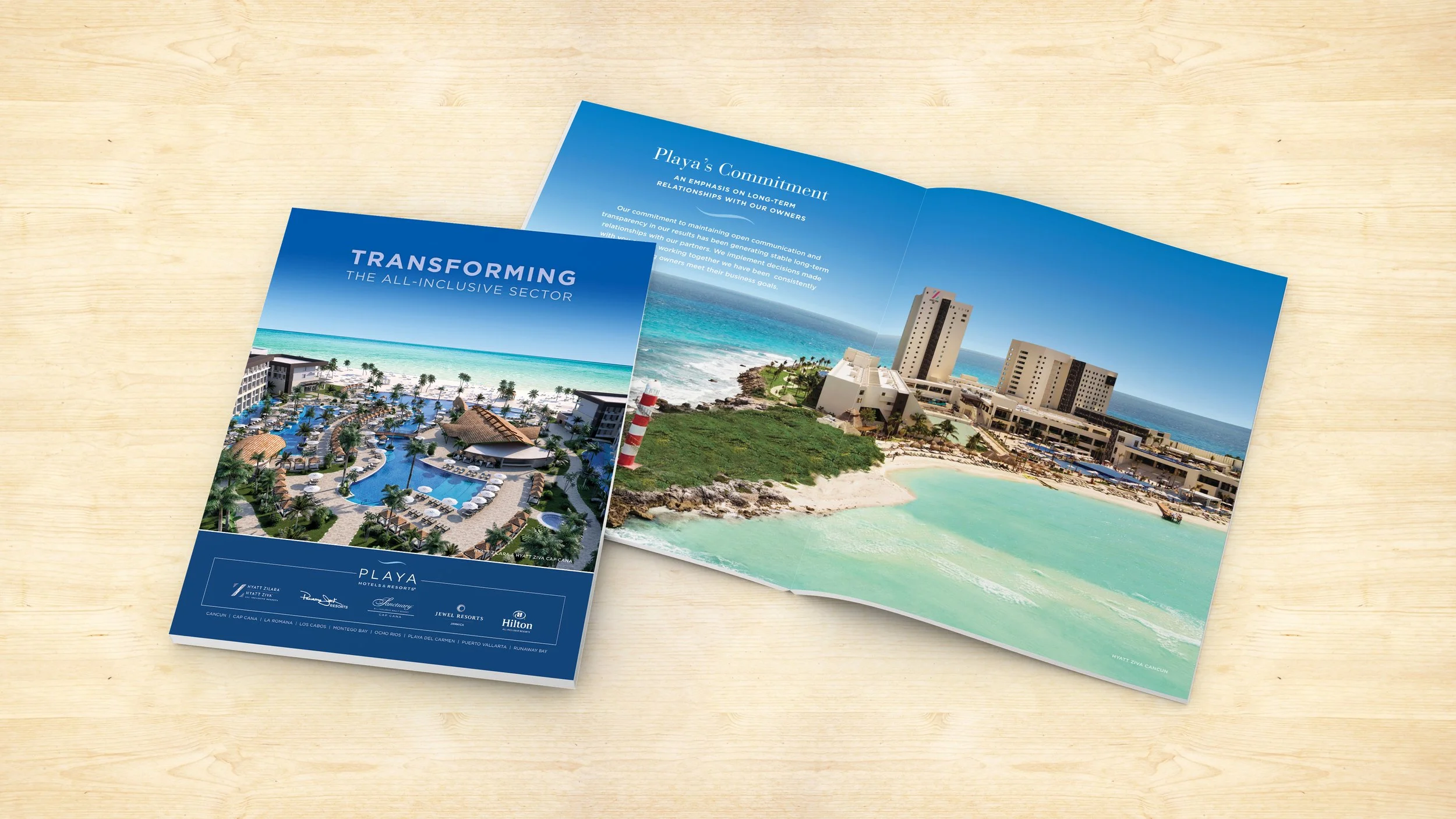 A corporate brochure for Playa Hotels & Resorts laying open on a table.
