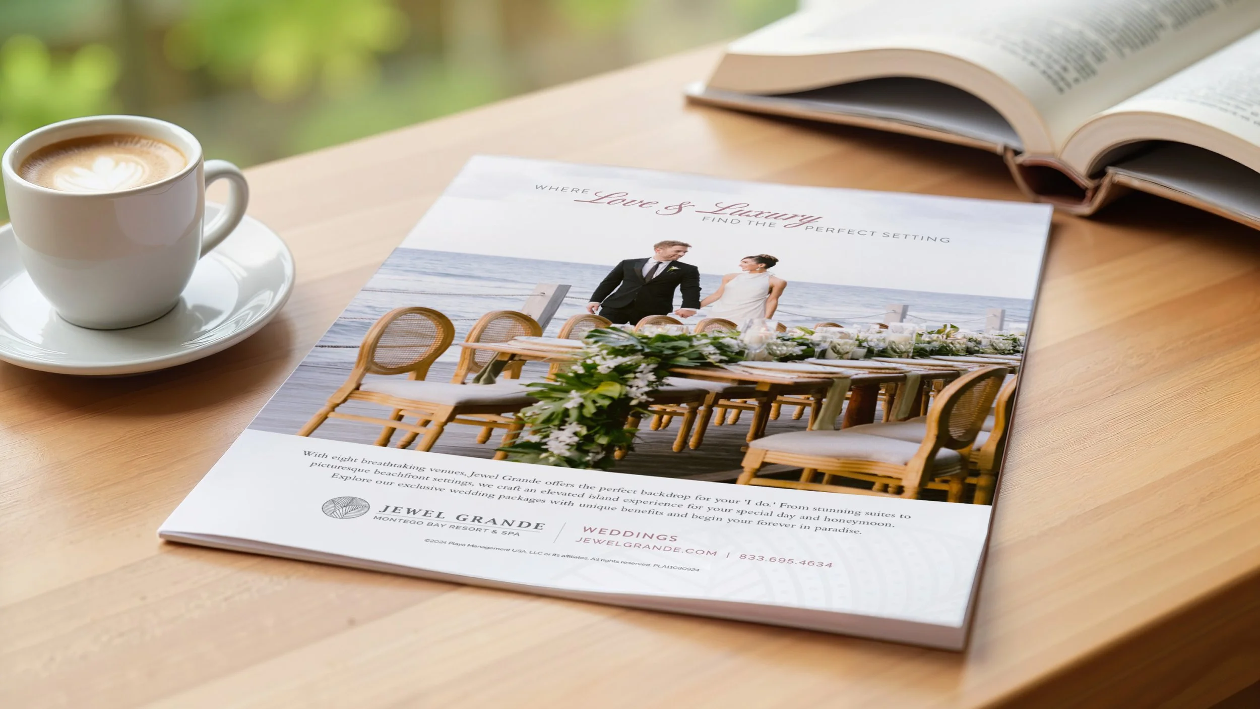 A full page magazine ad for weddings at Jewel Grande Resort & Spa displayed in a magazine open on a desk with a book and cup of coffee nearby.