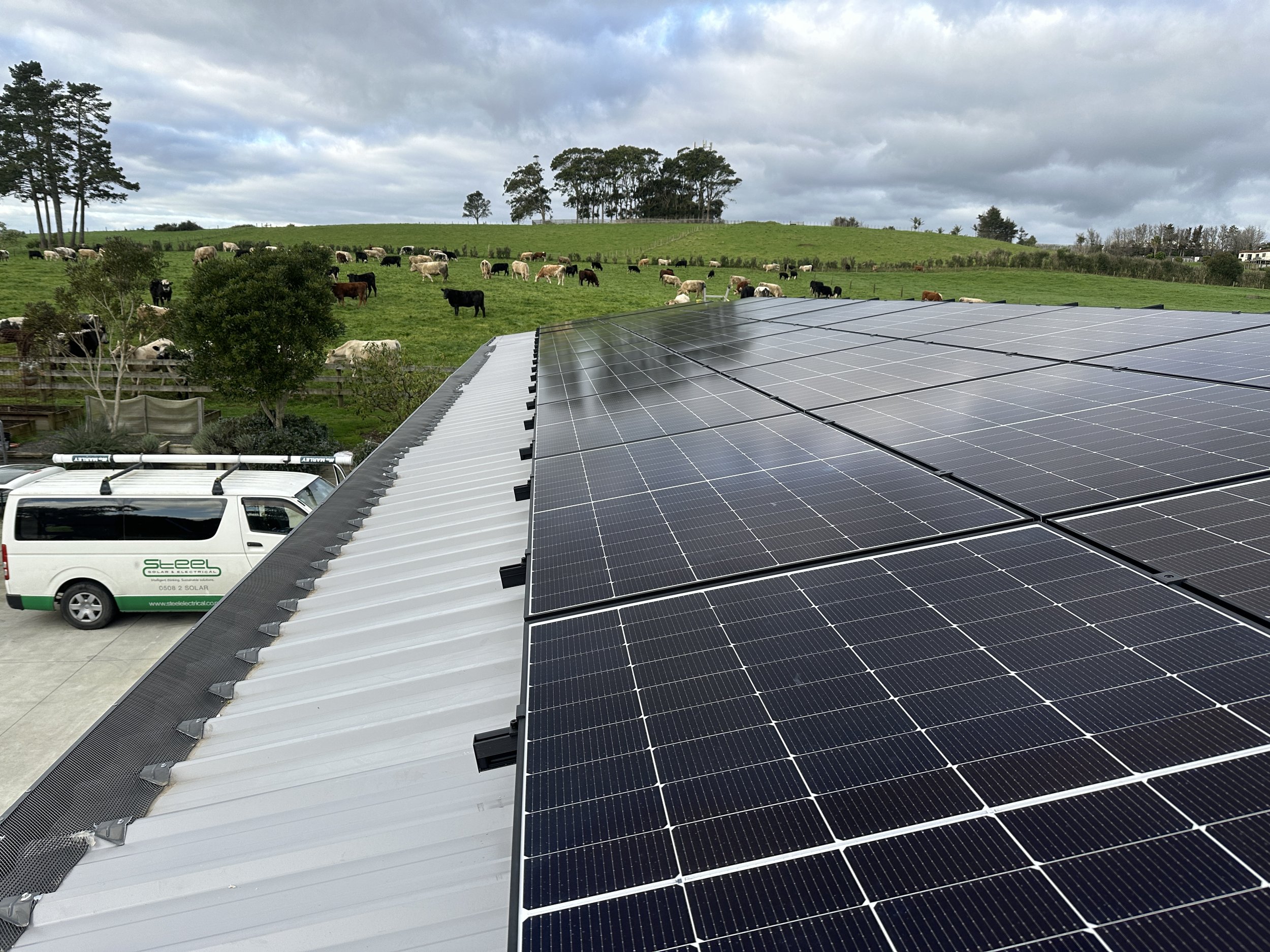 Solar panels on a rural property with a scenic view.