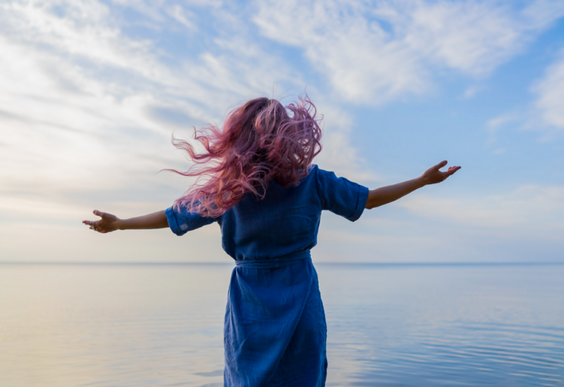 Woman facing the ocean