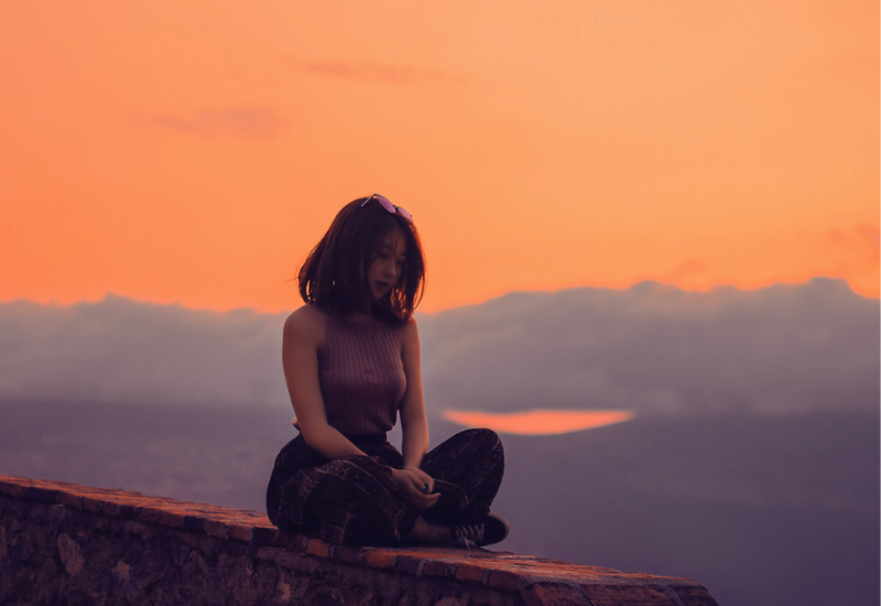 Woman sitting on a wall