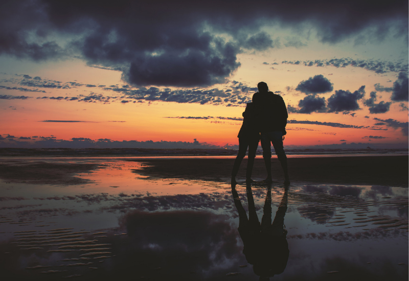 Couple on beach at sunset