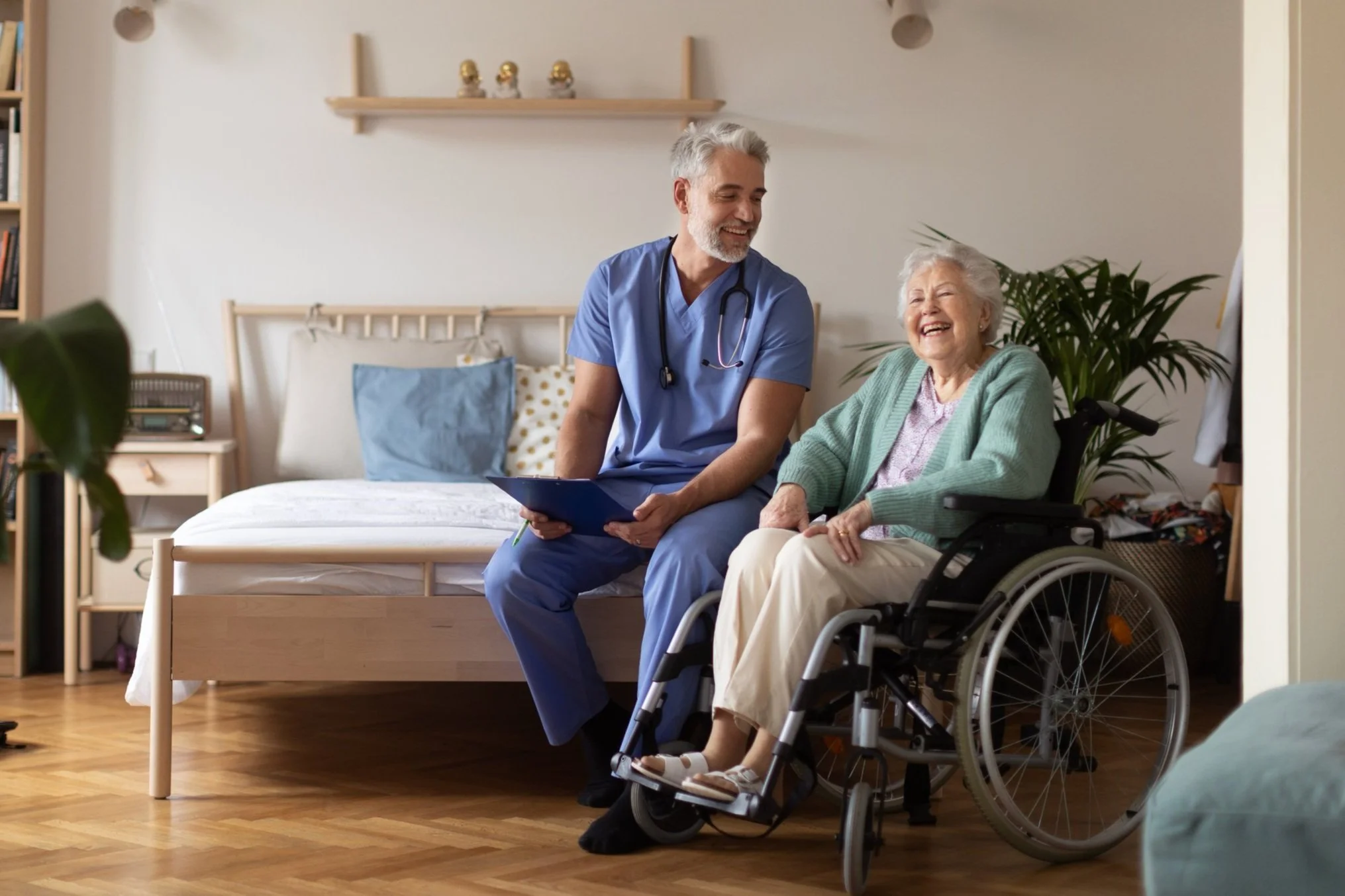 Photo of a doctor talking to a patient in a wheelchair in a long-term care home