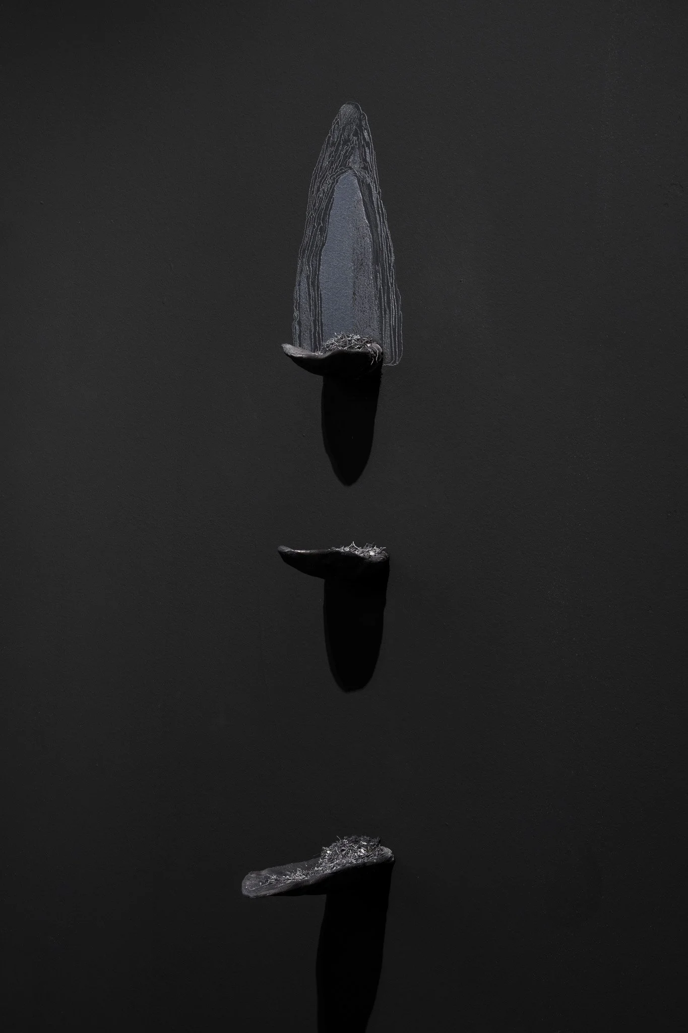  Tiffany Law,  Sentimentary formation , 2024, graphite and eraser dust on carved gypsum panel suspended in a wood frame. 2 ft  x 8 ft x 4 in. 