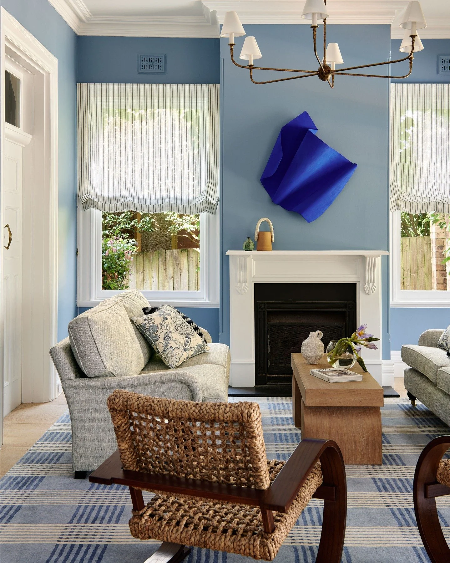KILLARA HOUSE - A symphony in blue &mdash; this lounge is a study in tonal layering.

The sculptural wall piece sets the rhythm, while woven textures, checked wool, and quiet linen harmonise across the space.

At Killara House, we gave classic detail