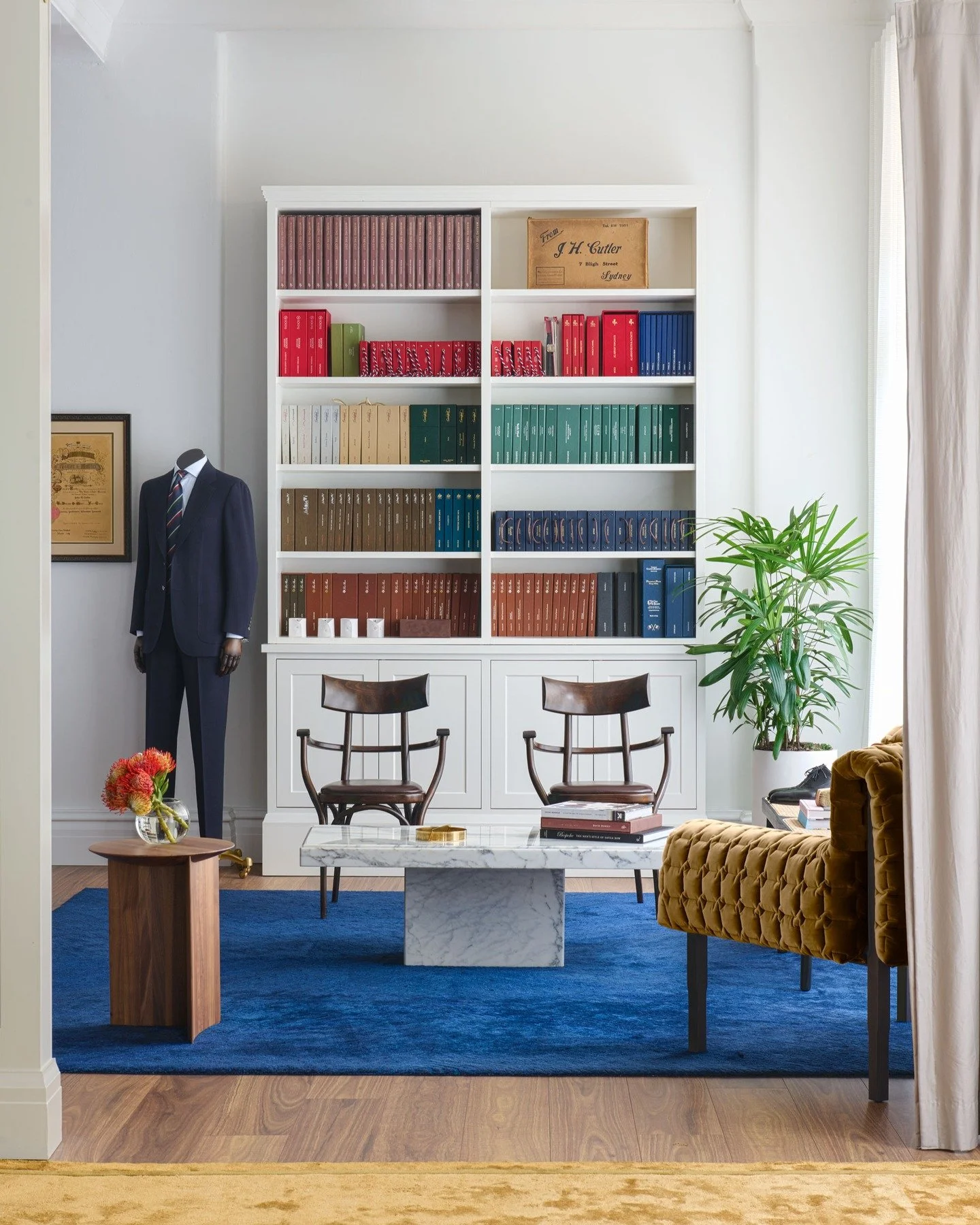 J H CUTLER - A room for precision and performance.

Cobalt wool underfoot. Tobacco velvet at your back. Marble cool to the touch.

Shelves stacked with the material swatches of bespoke tailoring &mdash; ordered, exact and quietly spectacular.

Interi