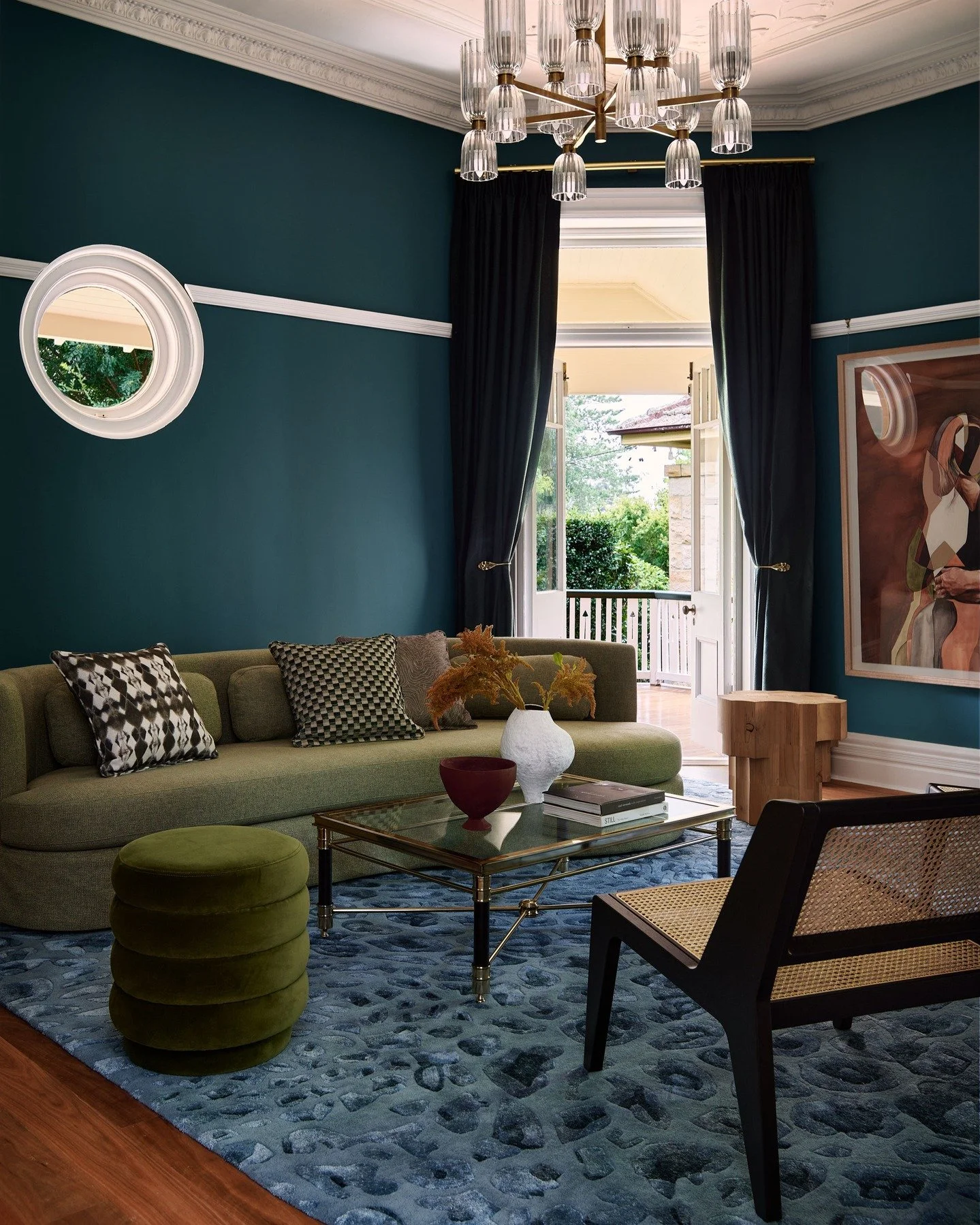 KILLARA HOUSE &mdash; A music room wrapped in saturated teal, with original cornice lines and floral ceiling plasterwork holding the perimeter. A faceted crystal chandelier centres the room, balancing classical detailing with a sharper silhouette. A 